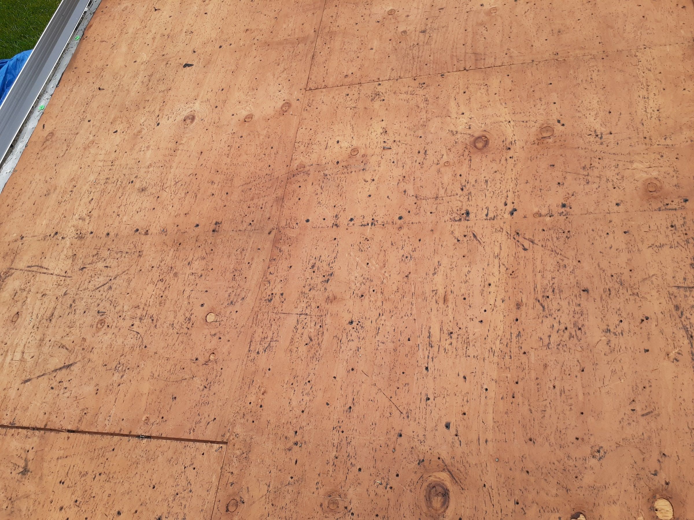 The old plywood deck stripped bare across a full slope, Huber Heights, Ohio.