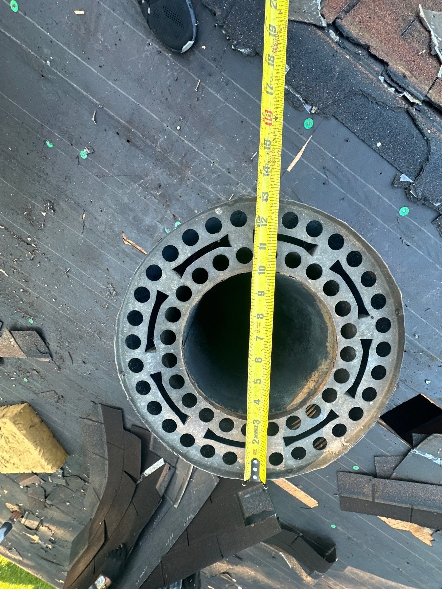 Tape measure across an open roof vent after the old shingles came off, Beavercreek, Ohio.