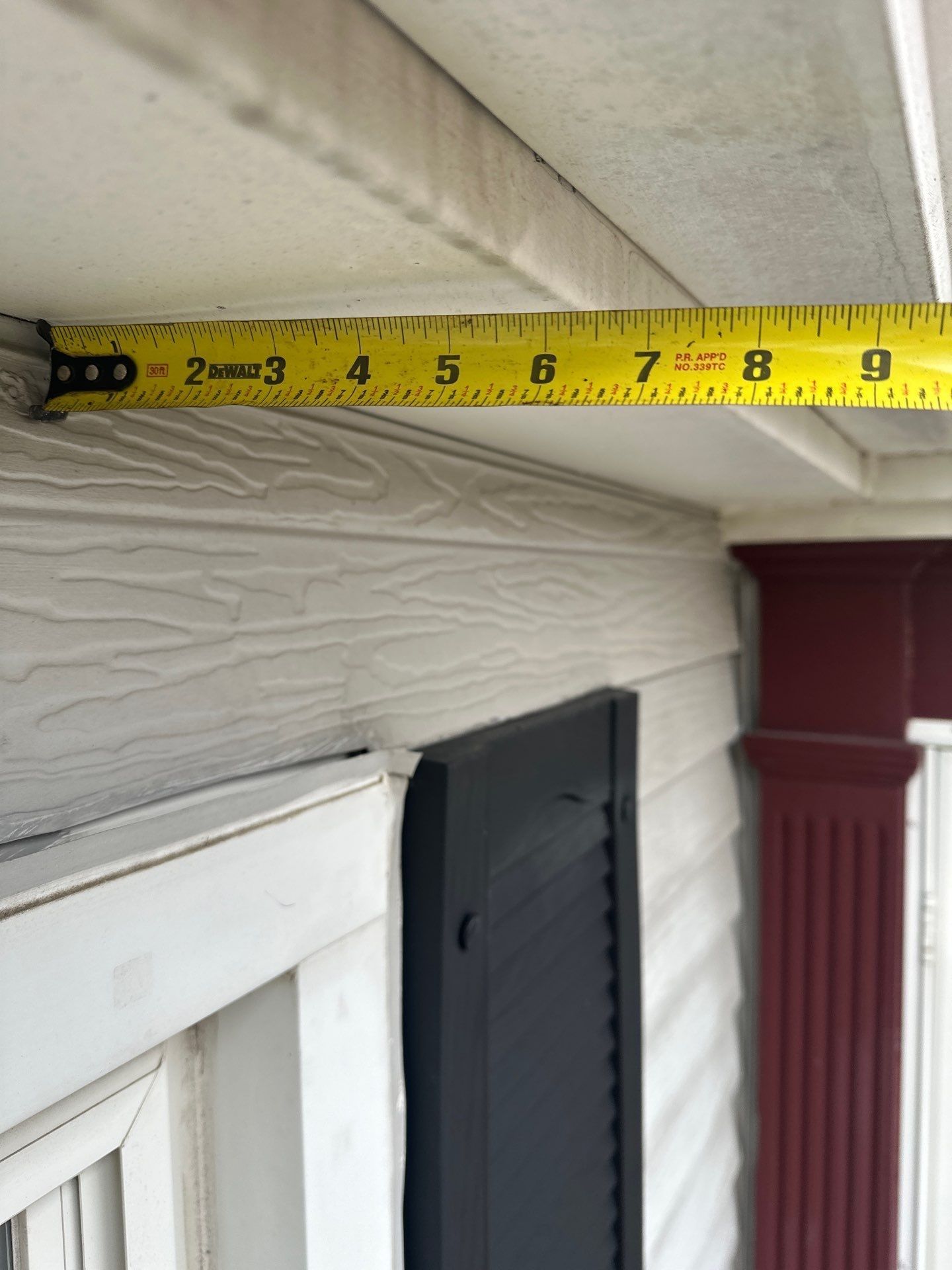 A tape measure across the soffit by the front door, Kettering, Ohio.
