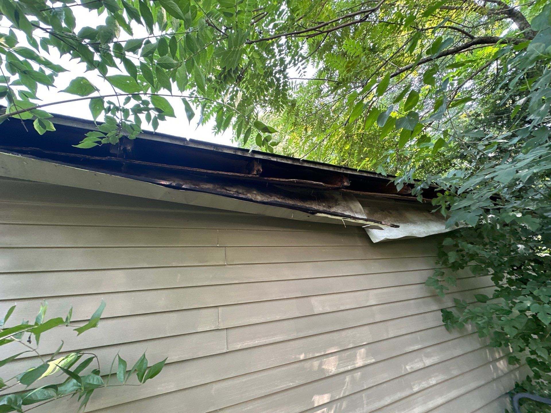 Rotted, broken wood at the corner of the garage roof edge, Beavercreek, Ohio.