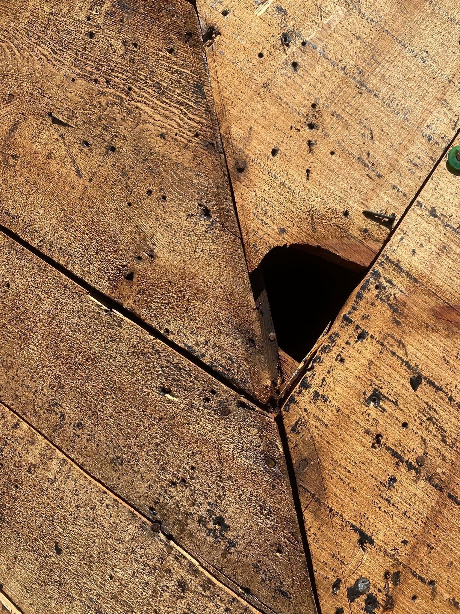Rotted hole where two deck boards meet at the hip, Beavercreek, Ohio.