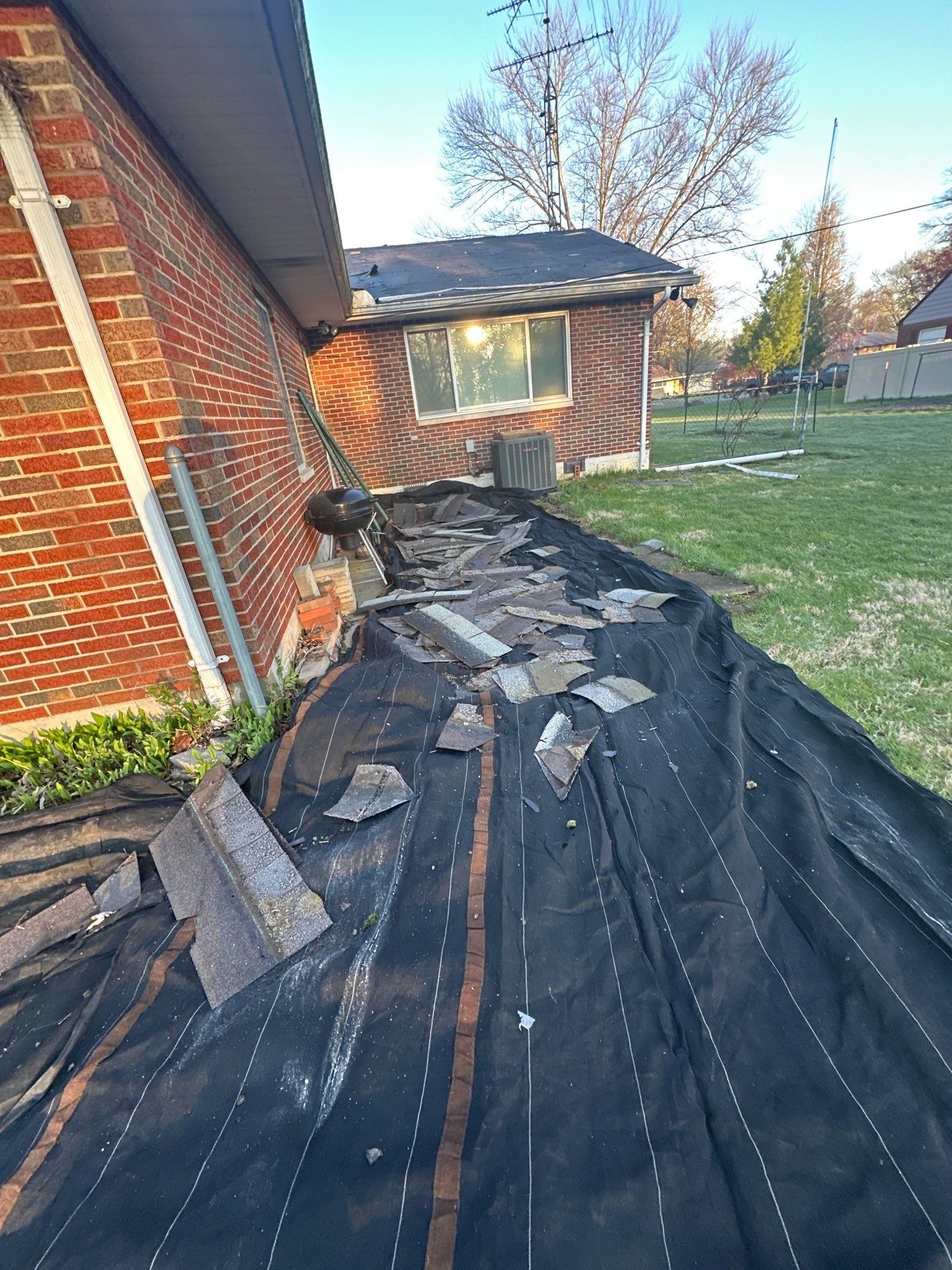 Tarps laid along the house to catch debris during tear-off, Beavercreek, Ohio.