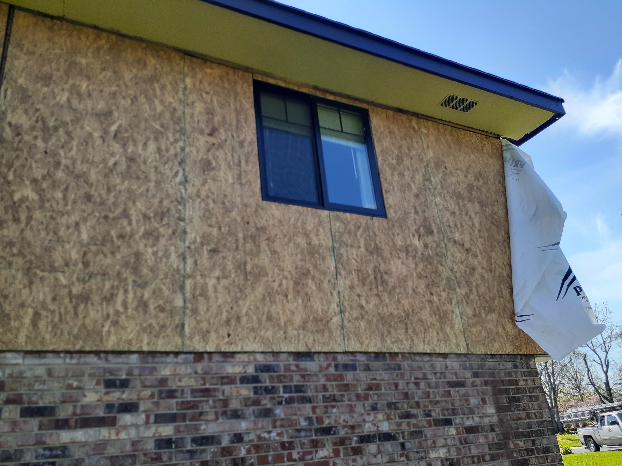 Sheathing seams on the back wall, with house wrap ready at the corner, Beavercreek, Ohio.