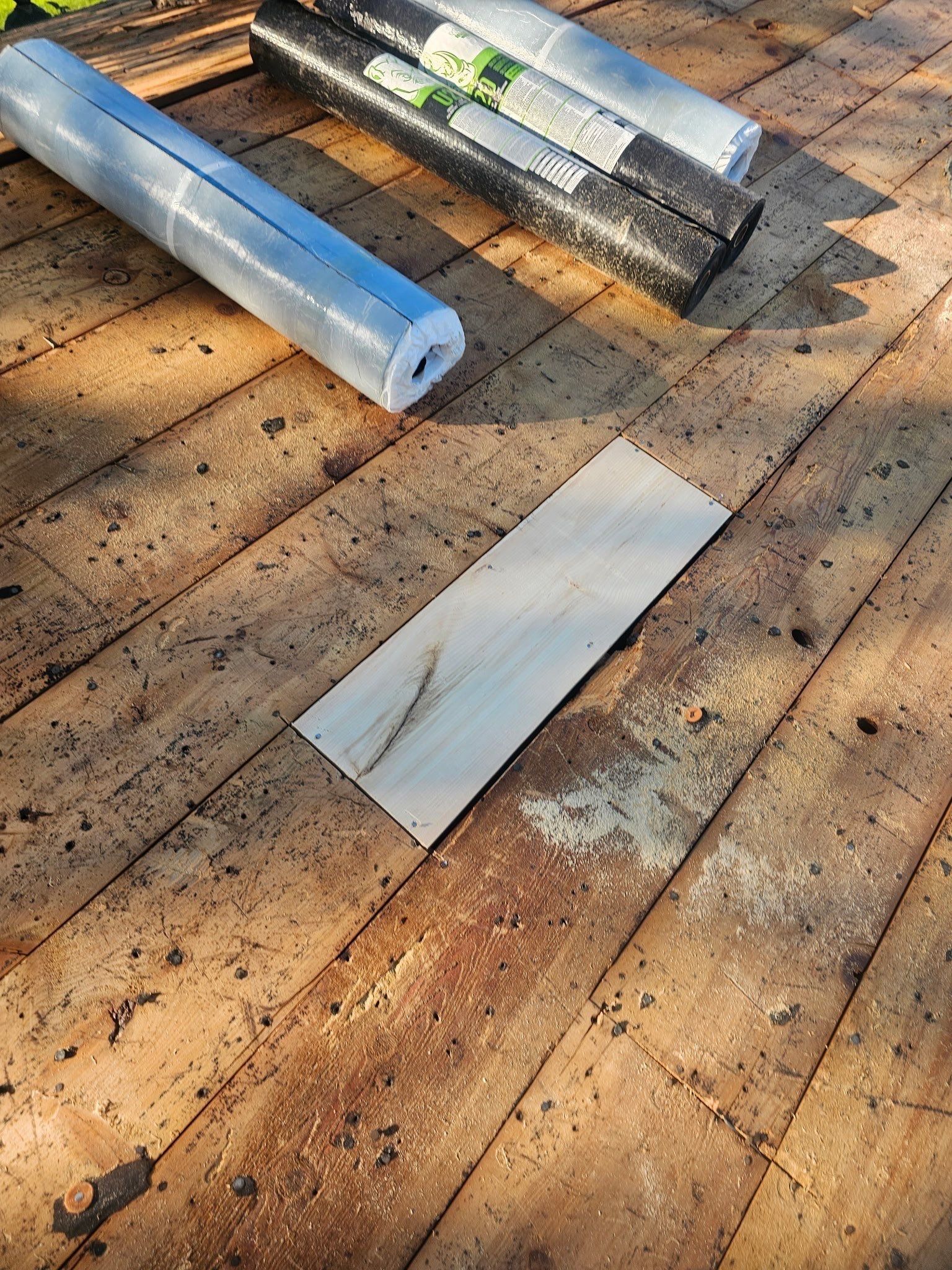 Rolls of underlayment waiting on the repaired deck, Kettering, Ohio.