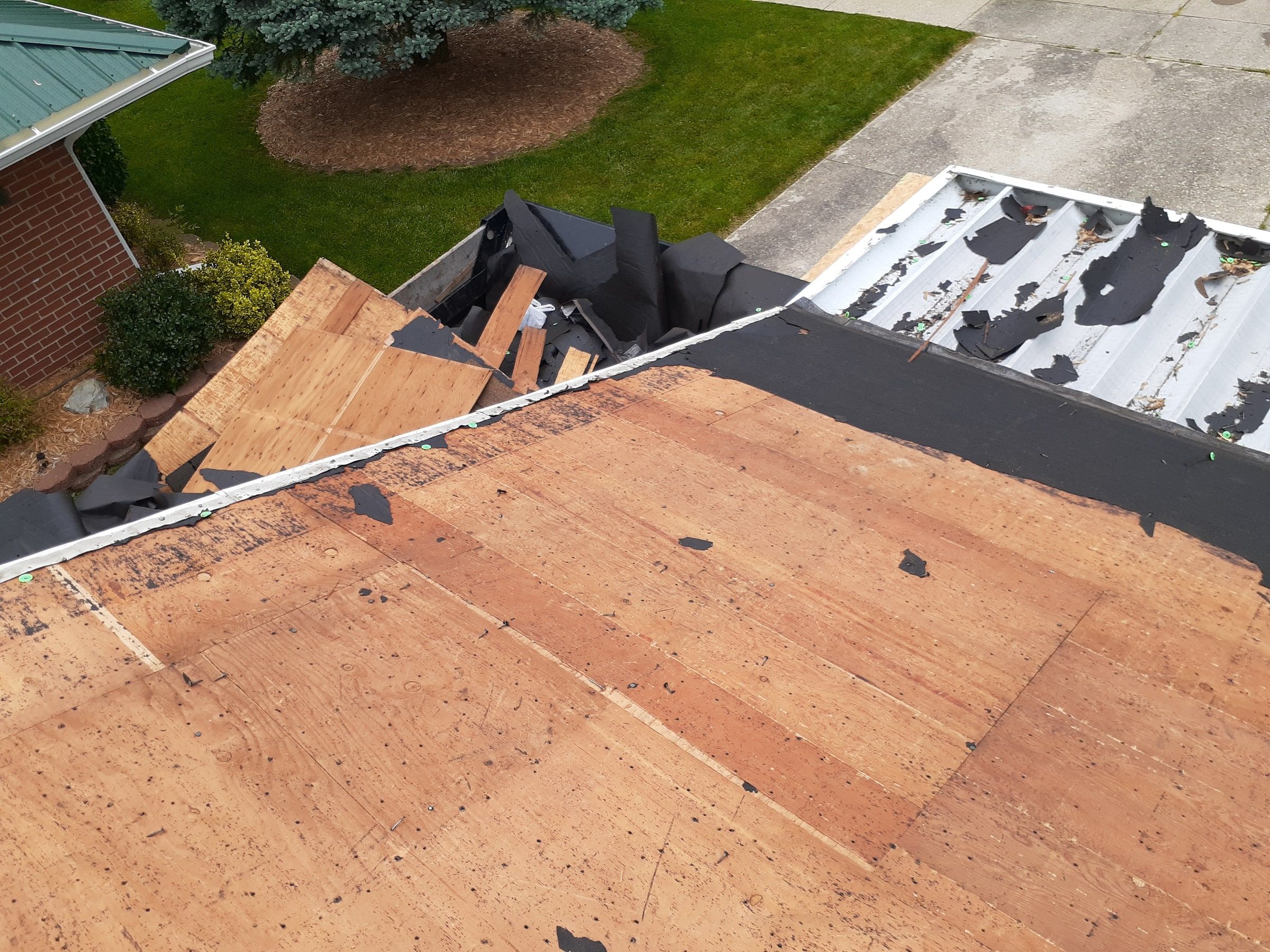 The bare deck above the trailer full of torn-off shingles, Huber Heights, Ohio.