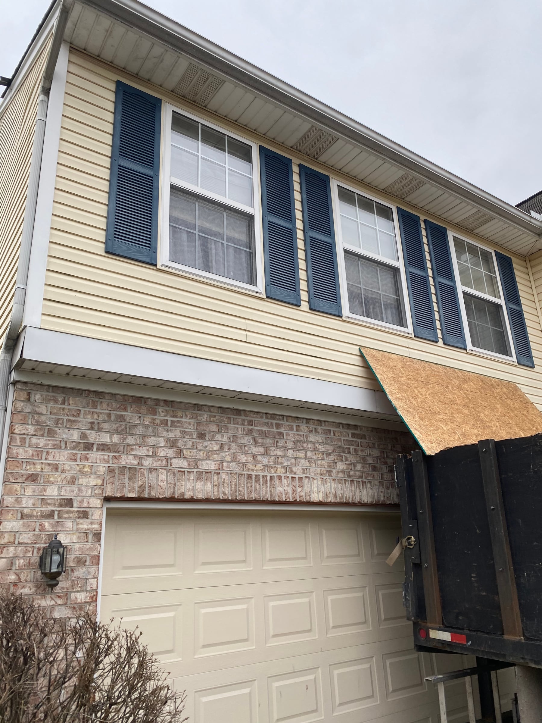 Plywood at the garage door and dump trailer
