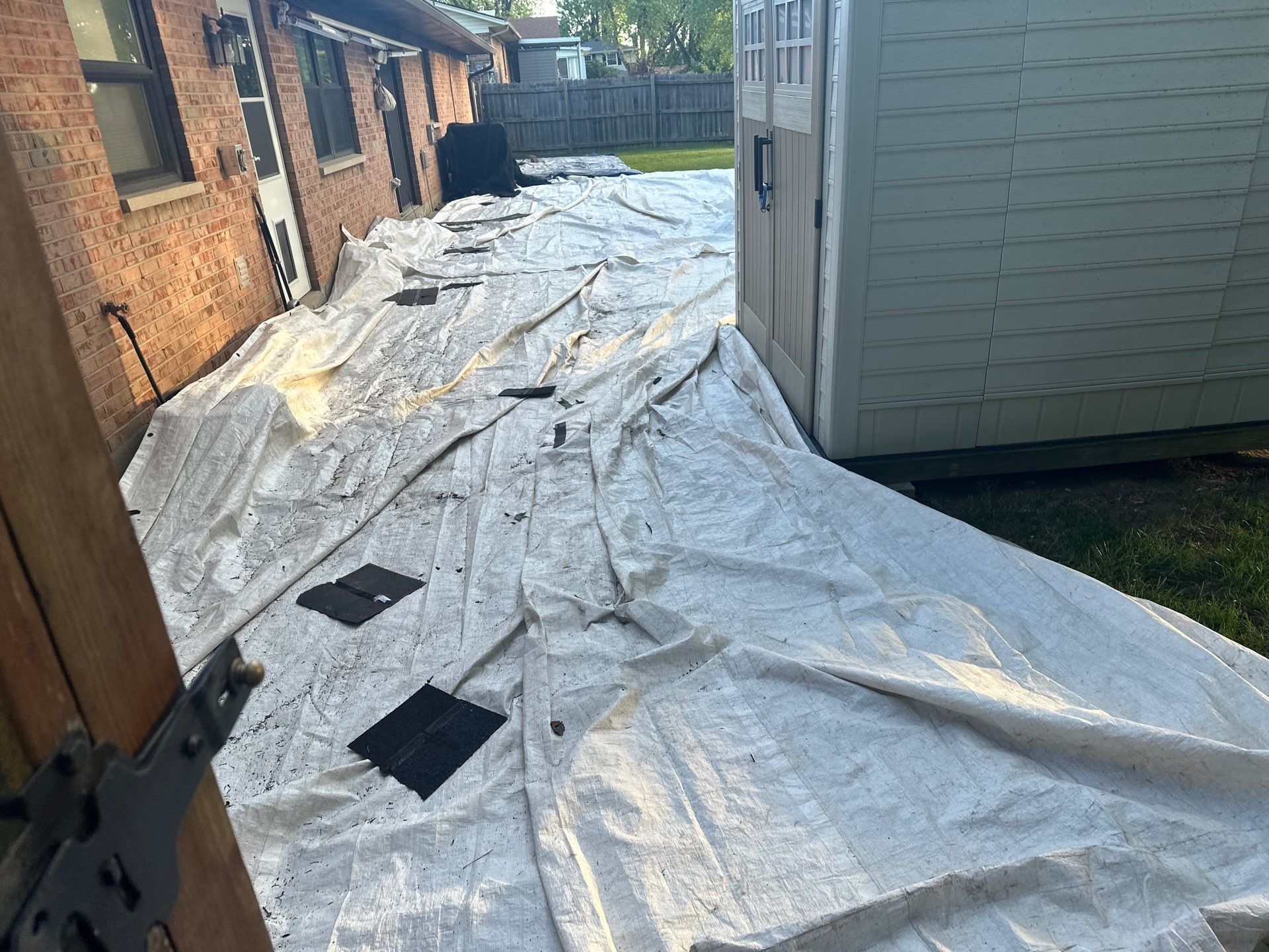 Tarps along the side of the house below the eave, Beavercreek, Ohio.