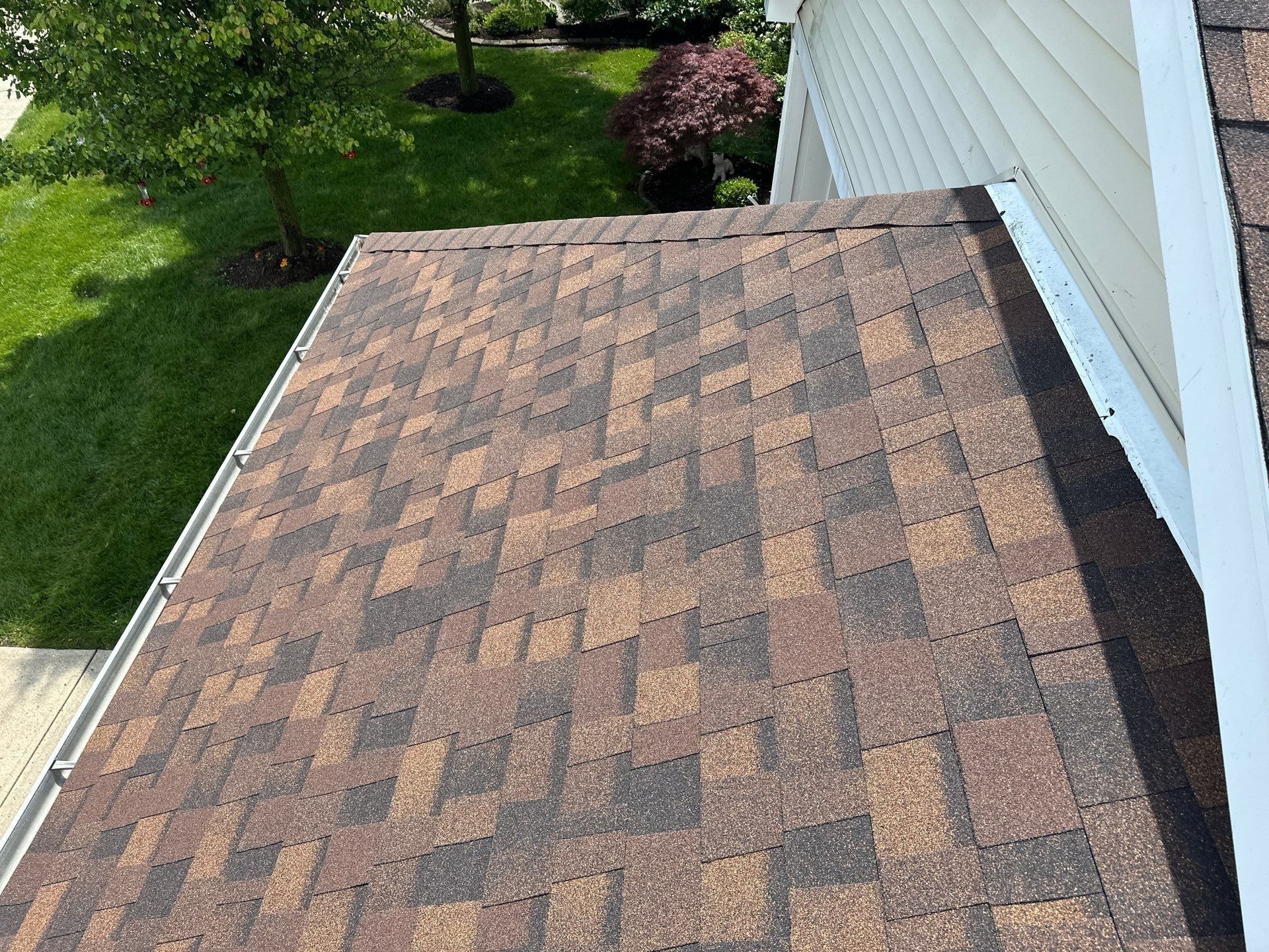 New shingles meeting the siding at a roof edge, Beavercreek, Ohio.