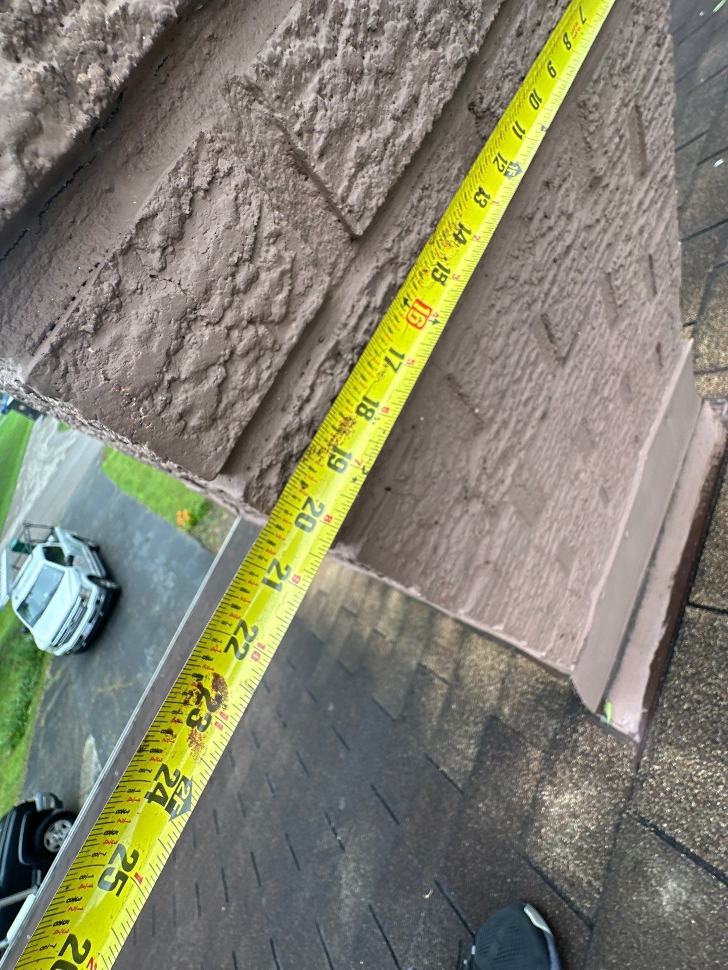 Tape measure run along the side of the chimney to size new flashing, Beavercreek, Ohio.