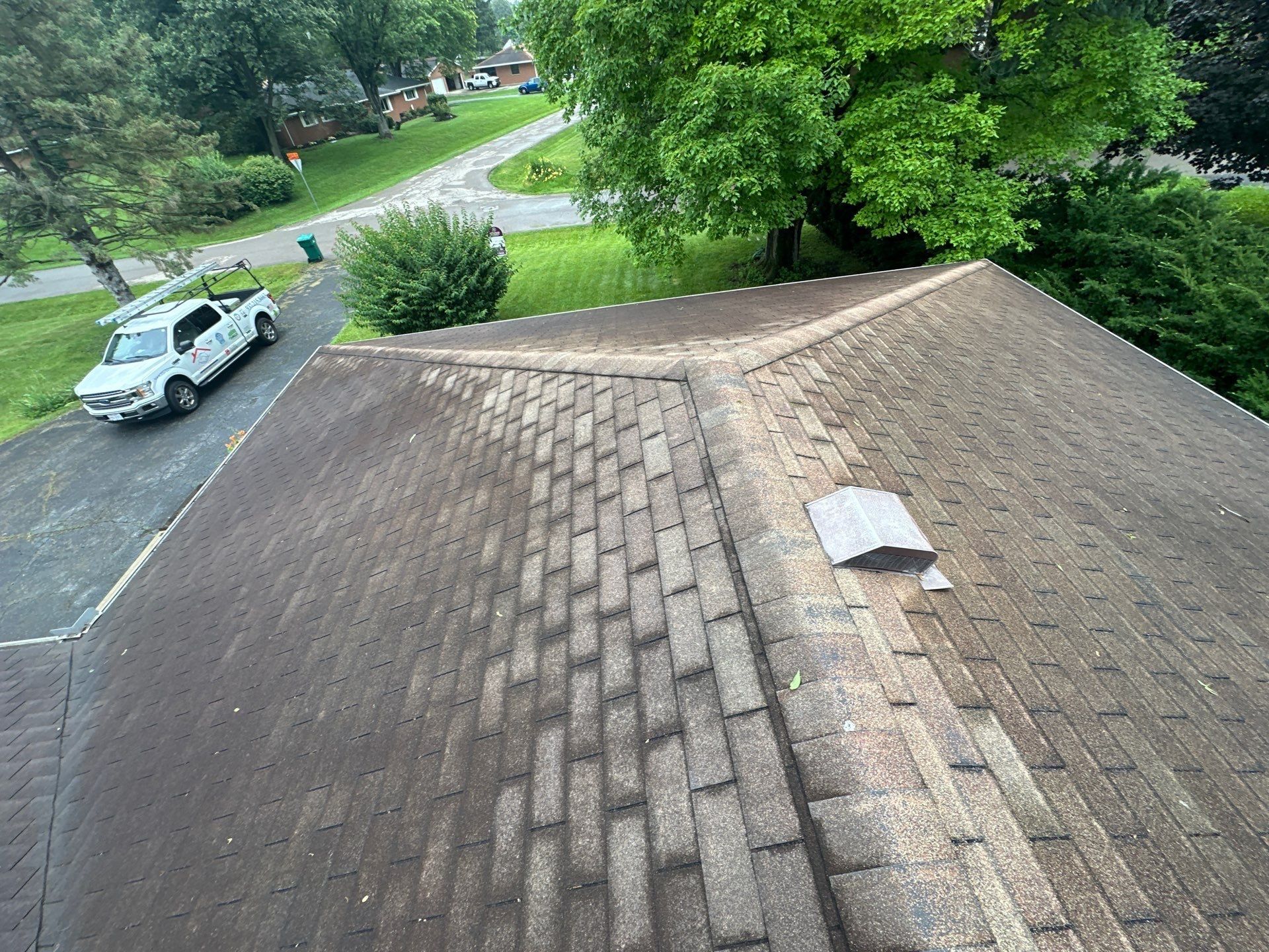 Hip roof overview showing aging three tab shingles and box vents, Beavercreek, Ohio.