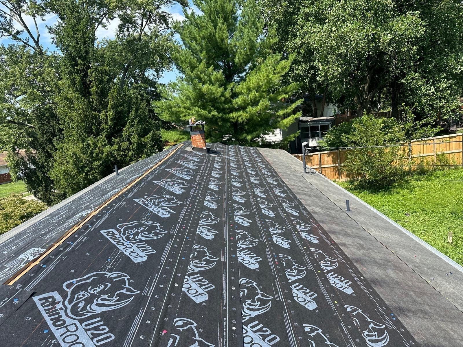 RhinoRoof synthetic underlayment covering the roof up to the chimney, Fairborn, Ohio.