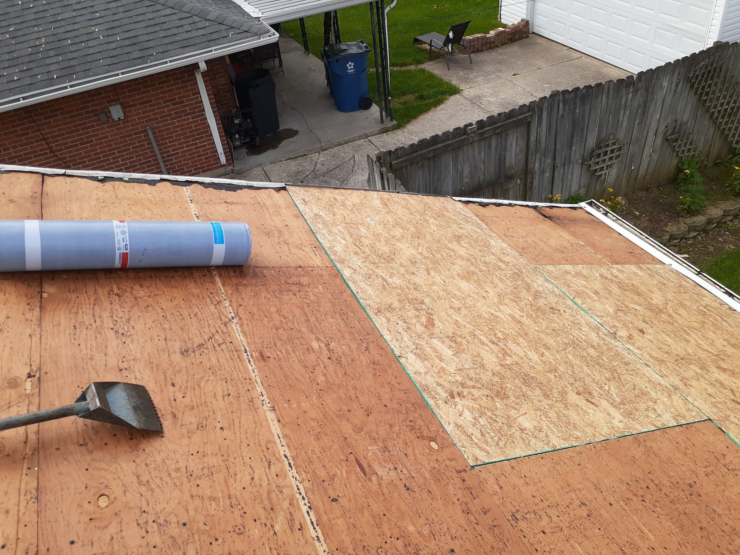 A new OSB section beside a roll of underlayment and a shingle shovel, Huber Heights, Ohio.