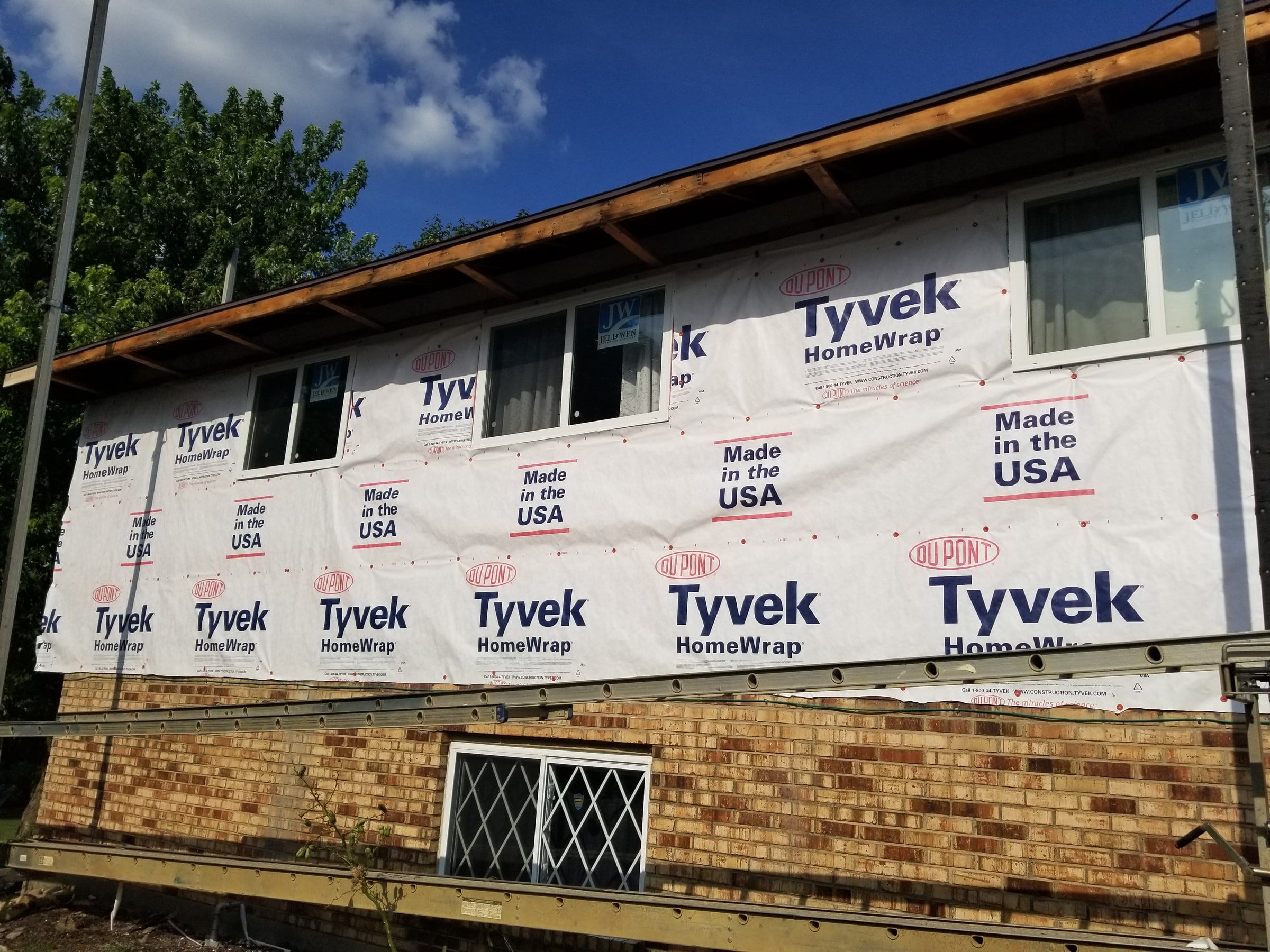 The wrapped upper wall above the brick, with the scaffold below, Beavercreek, Ohio.