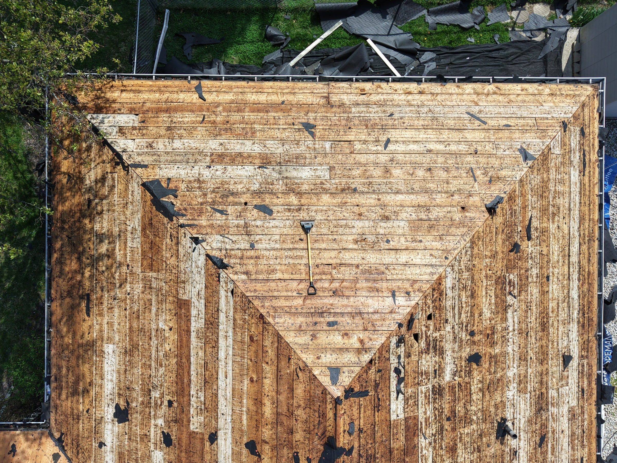 Drone photo of the old spaced plank decking exposed after tear-off, Beavercreek, Ohio.
