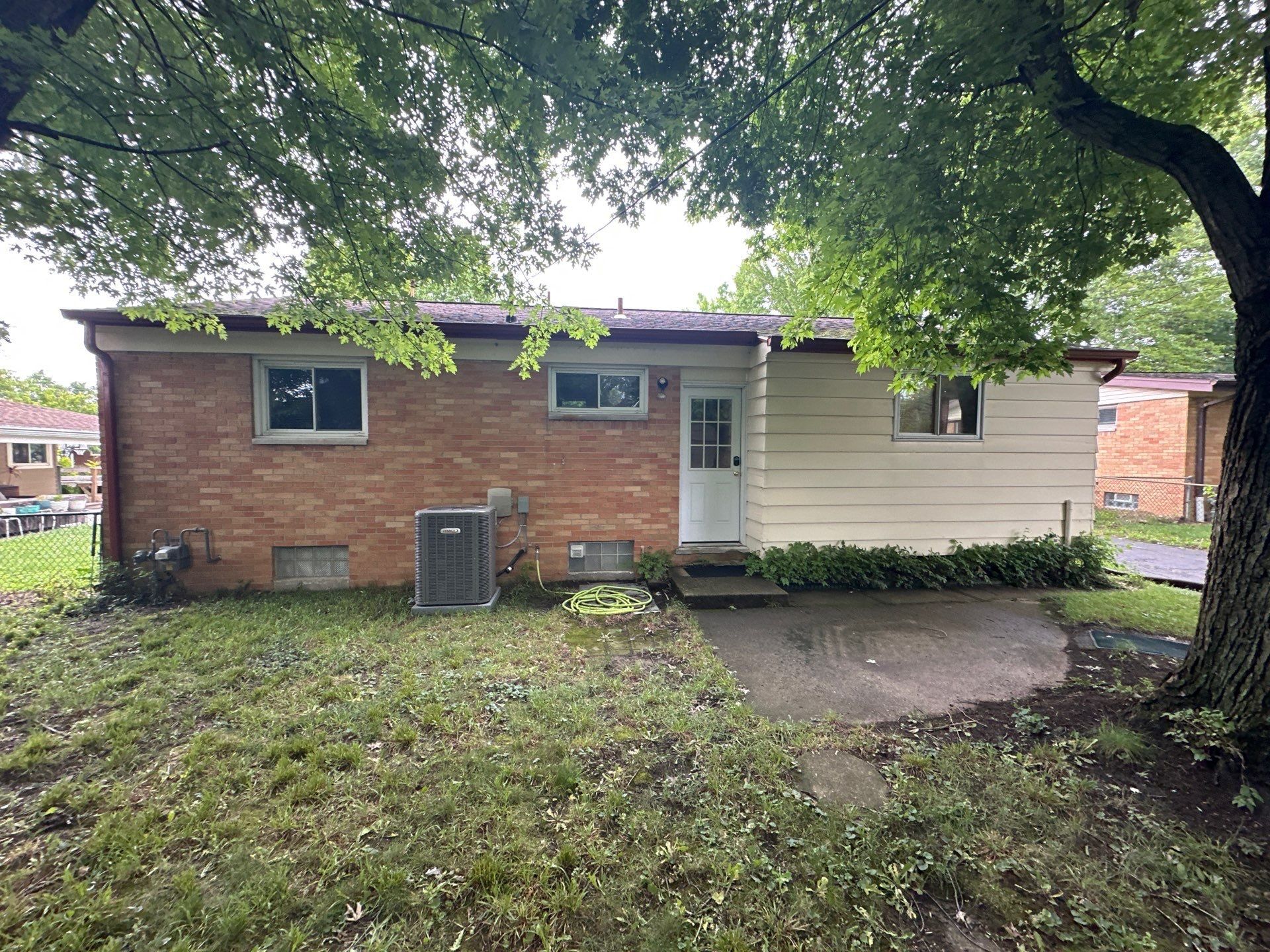 Back of the house under a large shade tree, before the new gutters, Kettering, Ohio.
