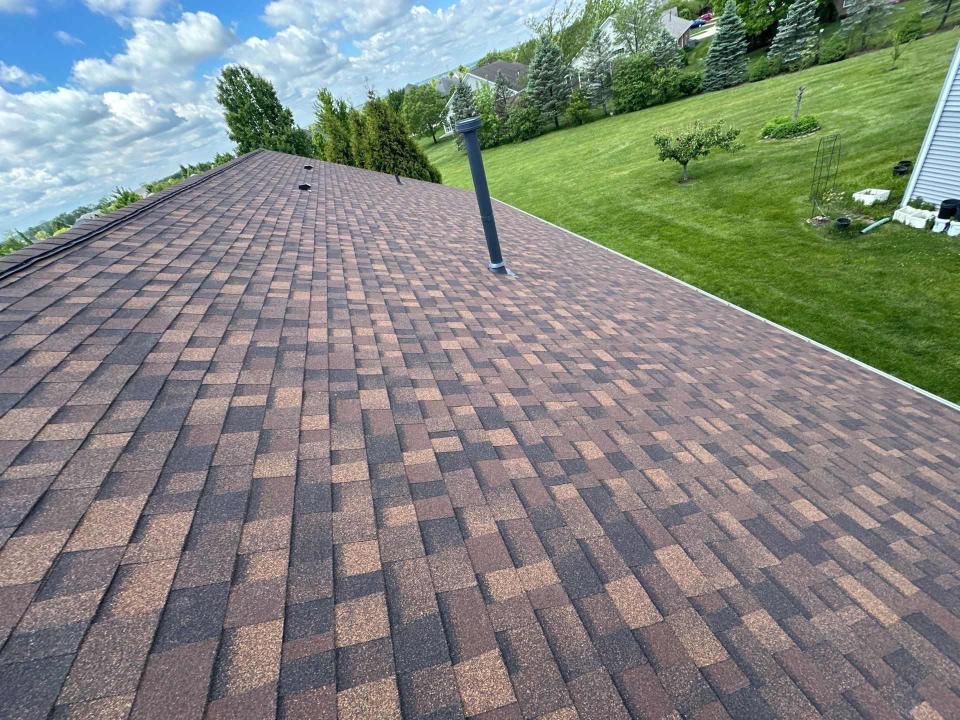 Finished roof plane with the flue pipe and the back yard, Beavercreek, Ohio.