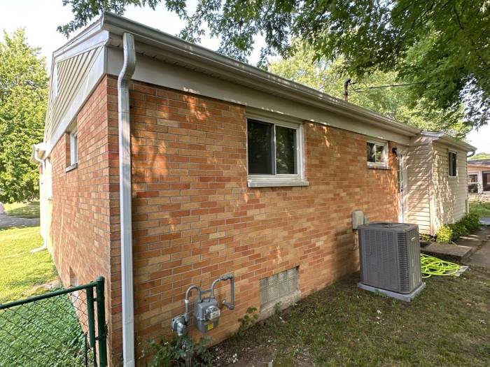 New seamless gutter and downspout on the back of the house beside the air conditioner, Kettering, Ohio.