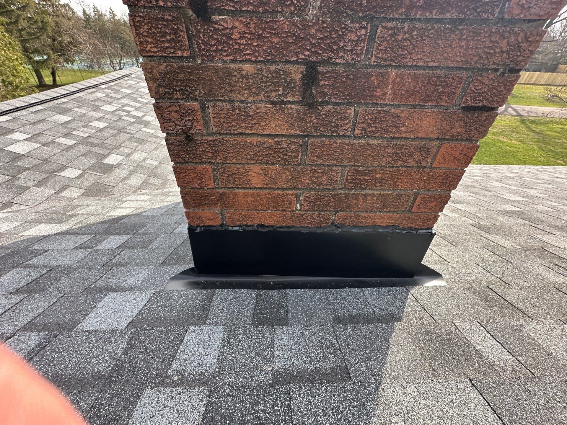 Base flashing across the chimney face