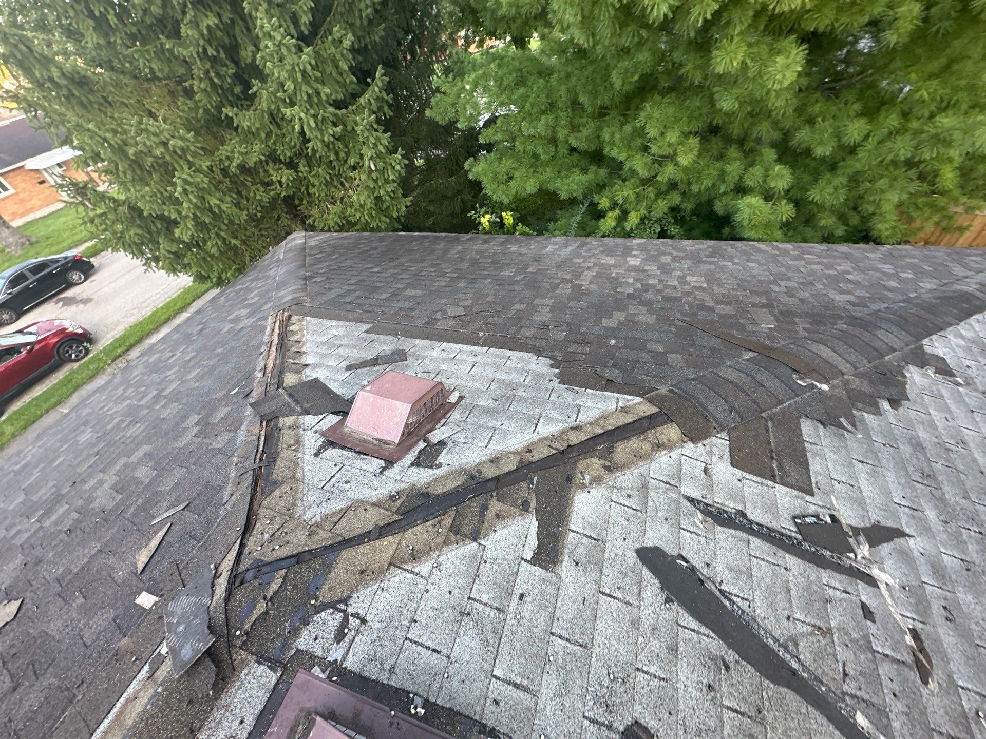 Tear-off around a roof vent showing the second layer of shingles underneath, Fairborn, Ohio.