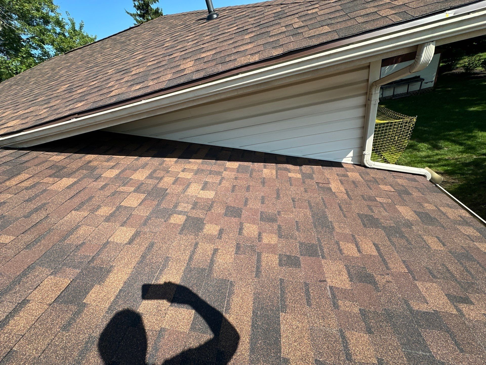 The finished lower roof where it meets the house gable and downspout, Dayton, Ohio.