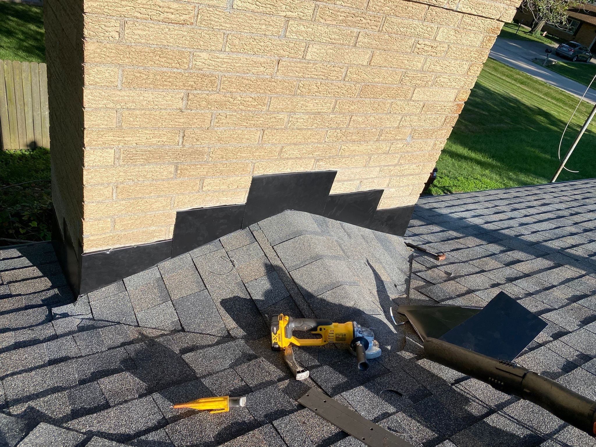 Shingles worked over the chimney cricket with stepped black flashing, Beavercreek, Ohio.