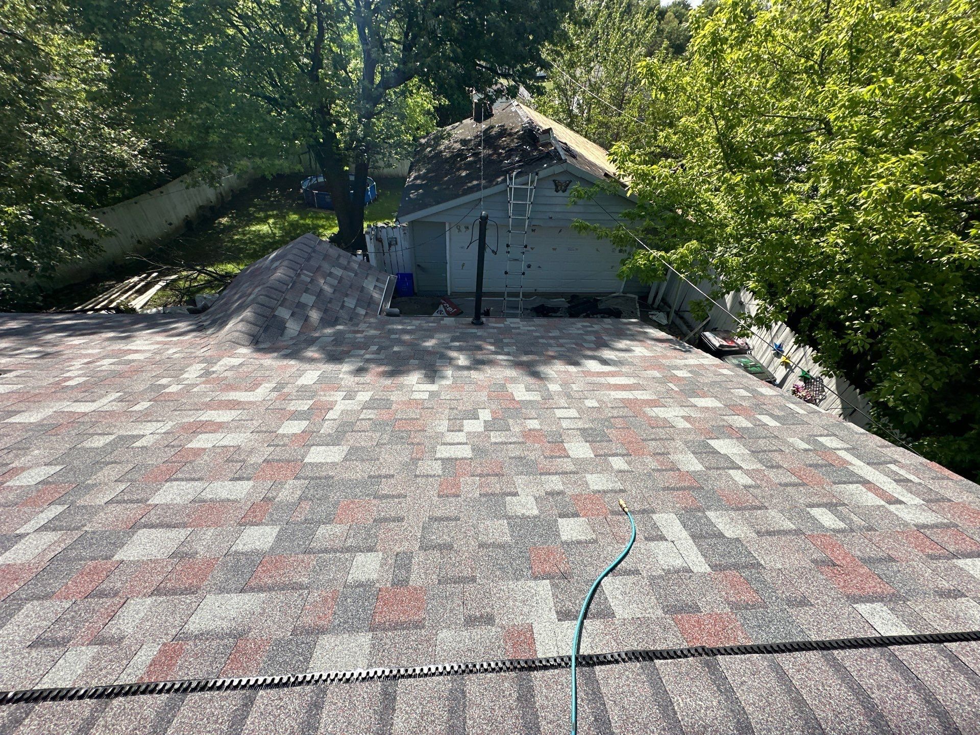 Plane, garden hose and the garage beyond