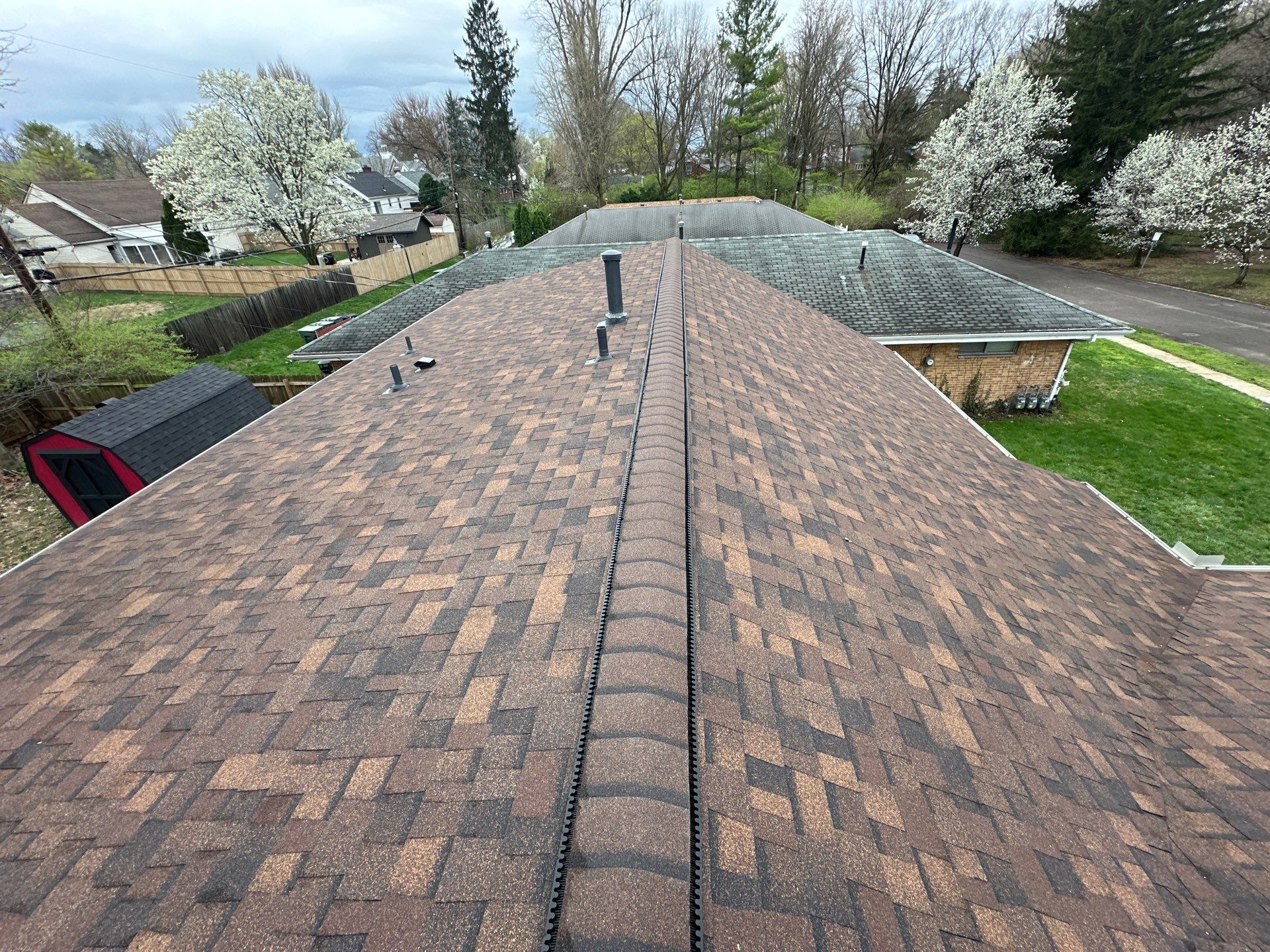 Ridge view of a completed asphalt-shingle roof replacement on a Dayton, Ohio home.