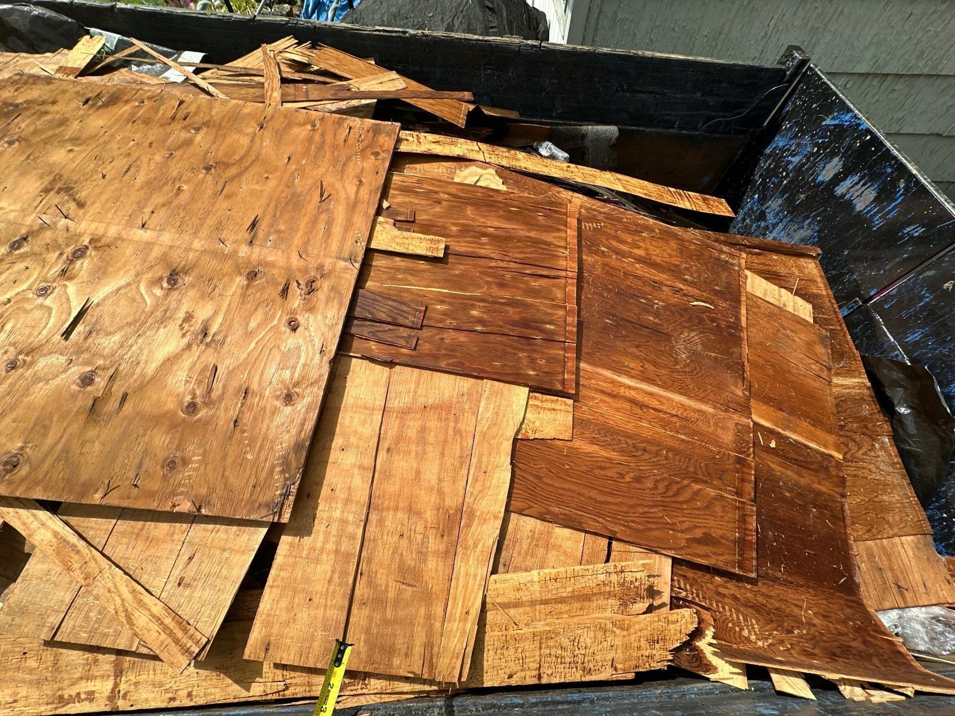 Torn-off plywood sheathing heaped in the dumpster, Dayton, Ohio.