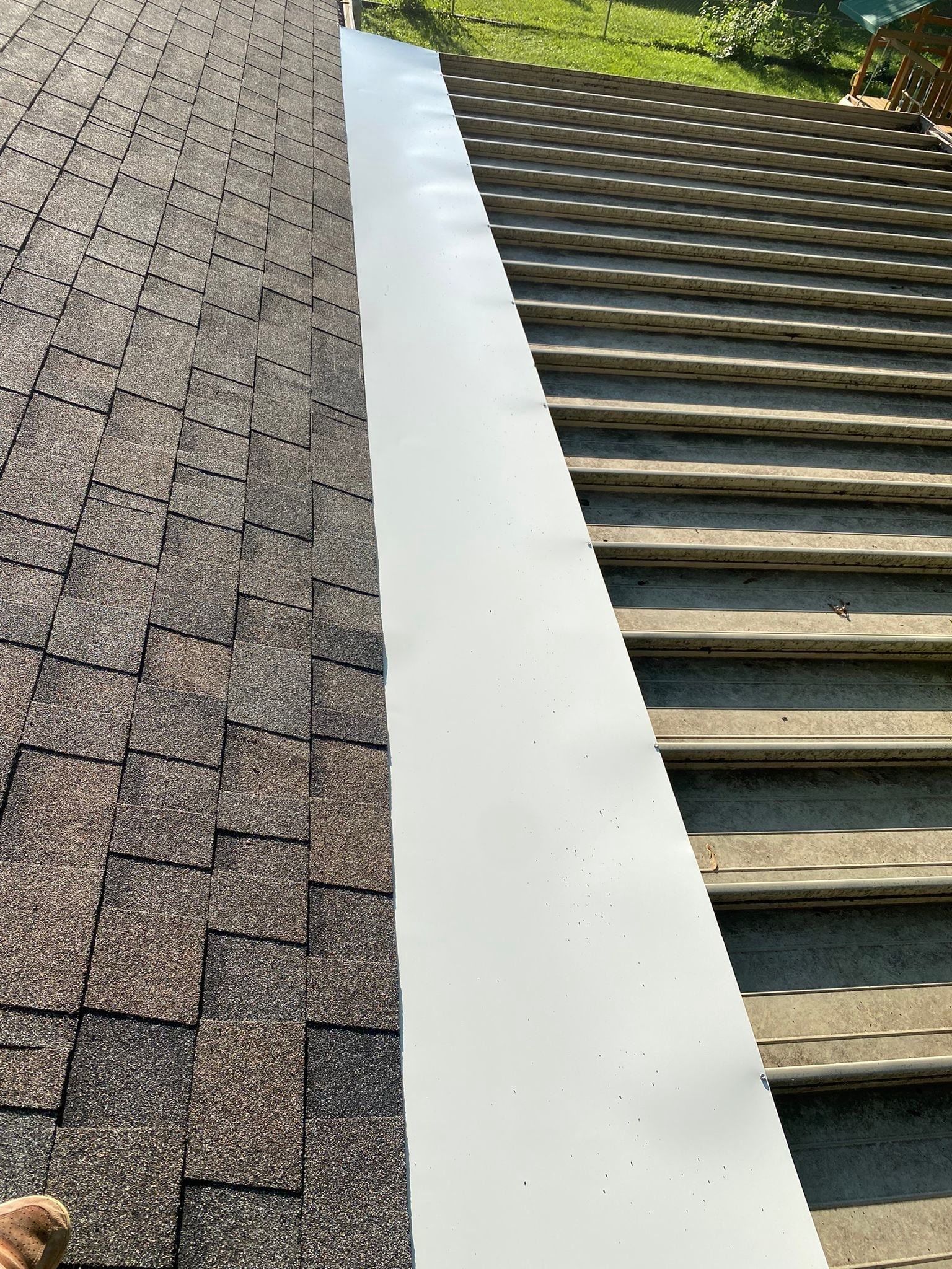 White metal panel joining the new shingles to the sunroom roof, Beavercreek, Ohio.