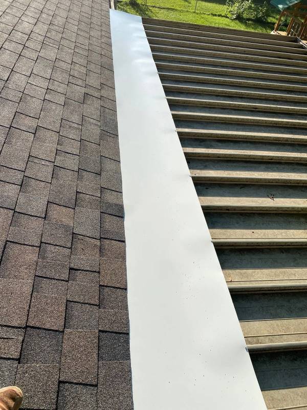 White metal panel joining the new shingles to the sunroom roof, Beavercreek, Ohio.