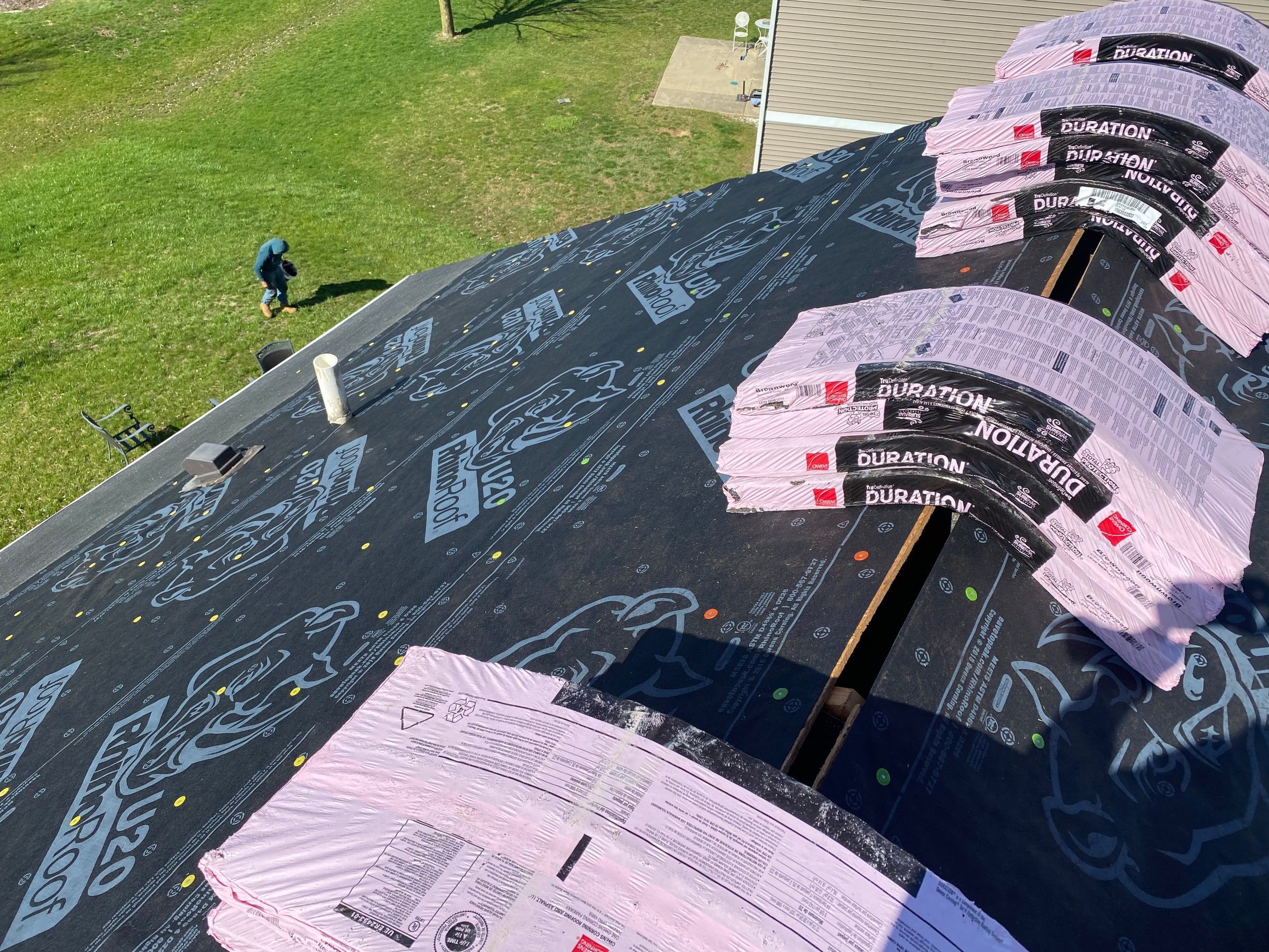 Underlayment across the roof with bundles staged along the ridge, Xenia, Ohio.
