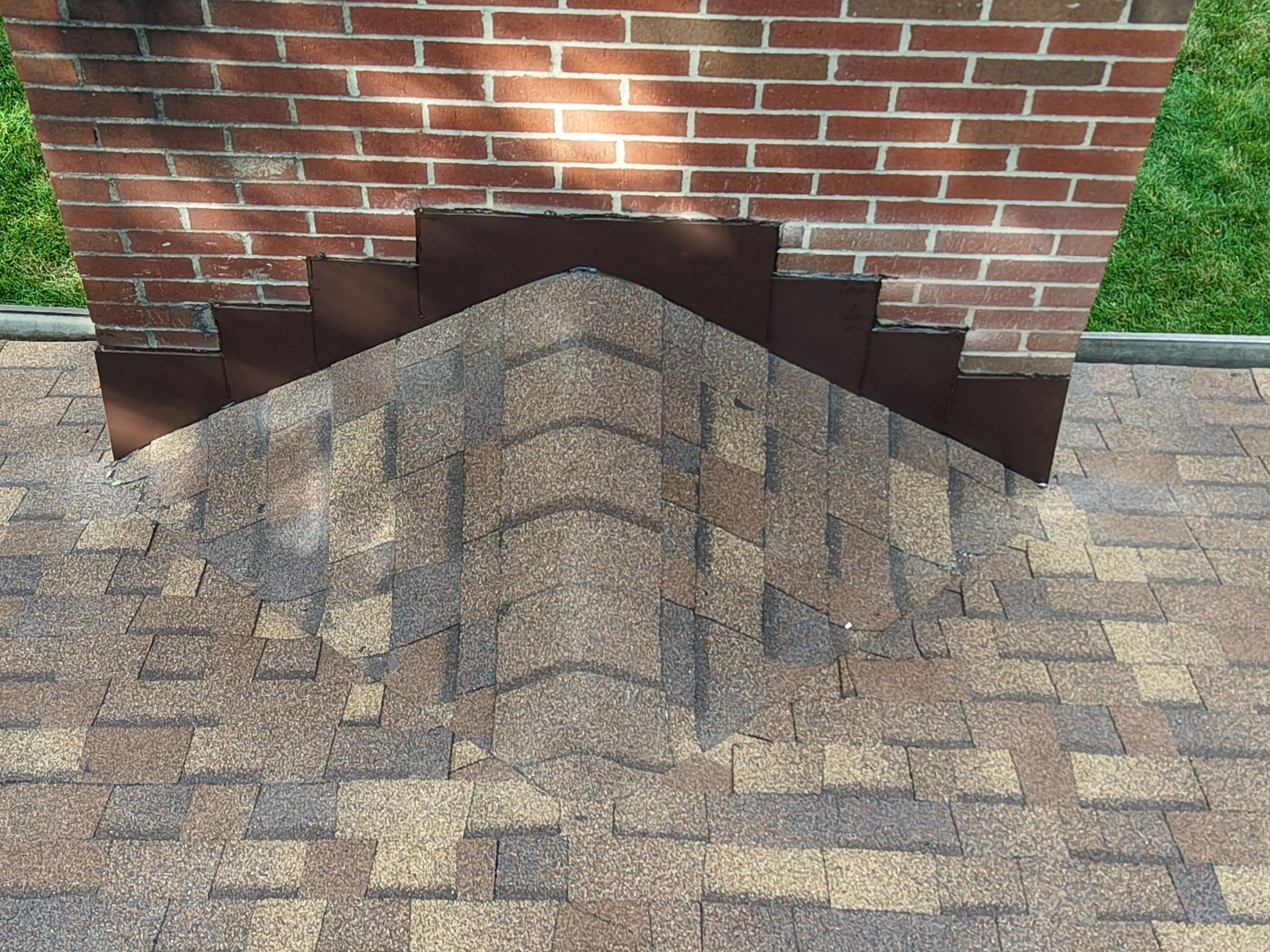 Shingles stepped against the chimney brick