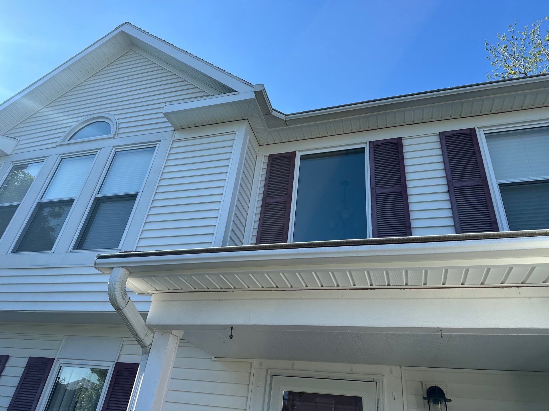 Front gable, arched window and porch eave