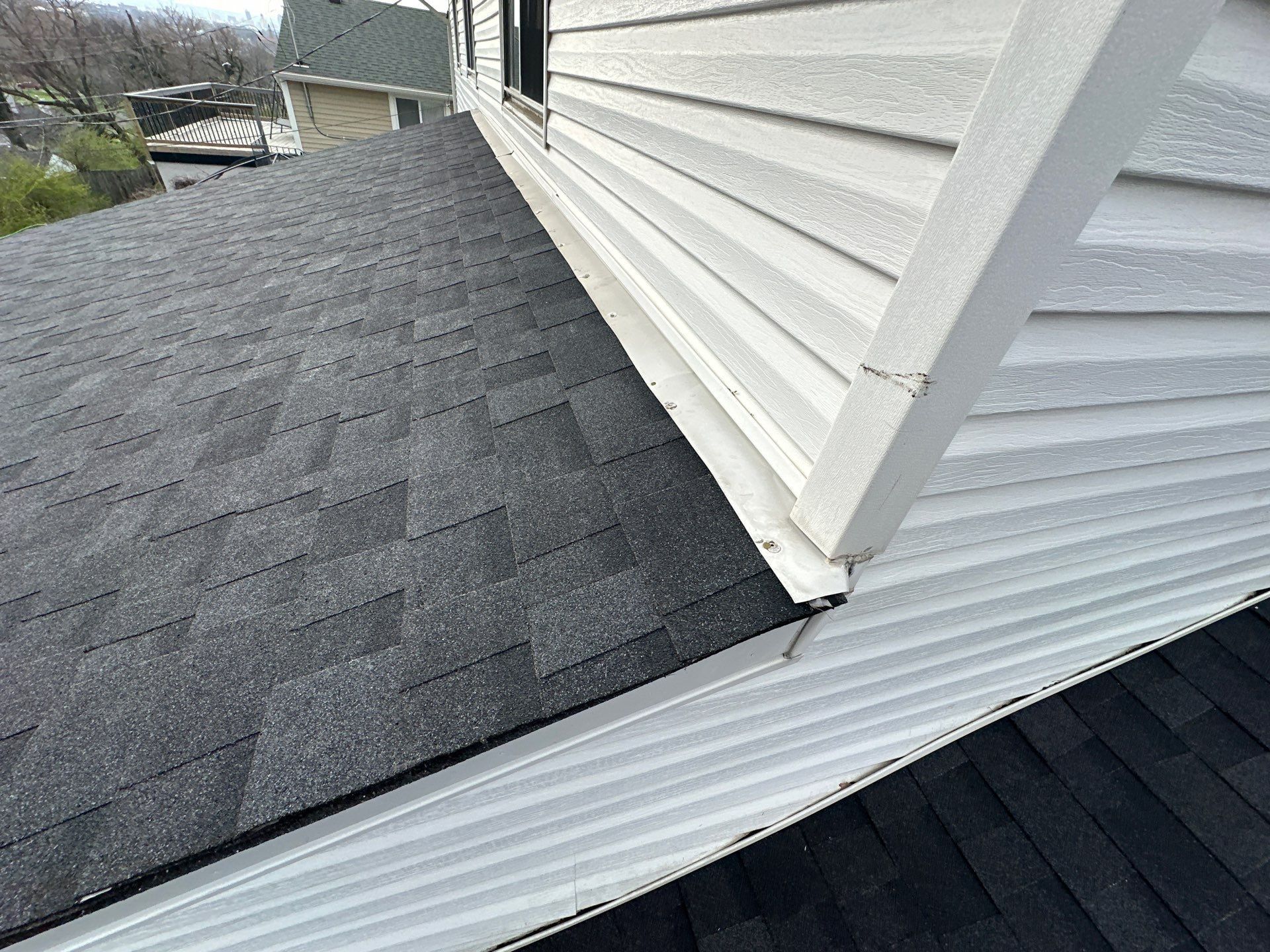 Shingles cut in against white siding