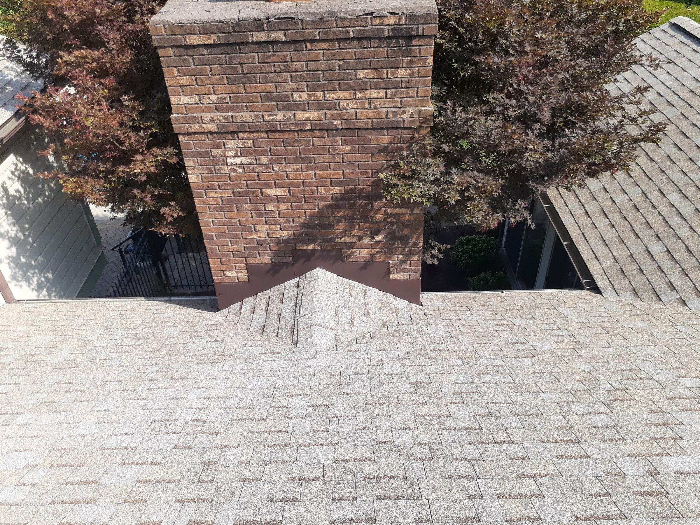 Chimney with its finished cricket and flashing on the new roof, Jamestown, Ohio.