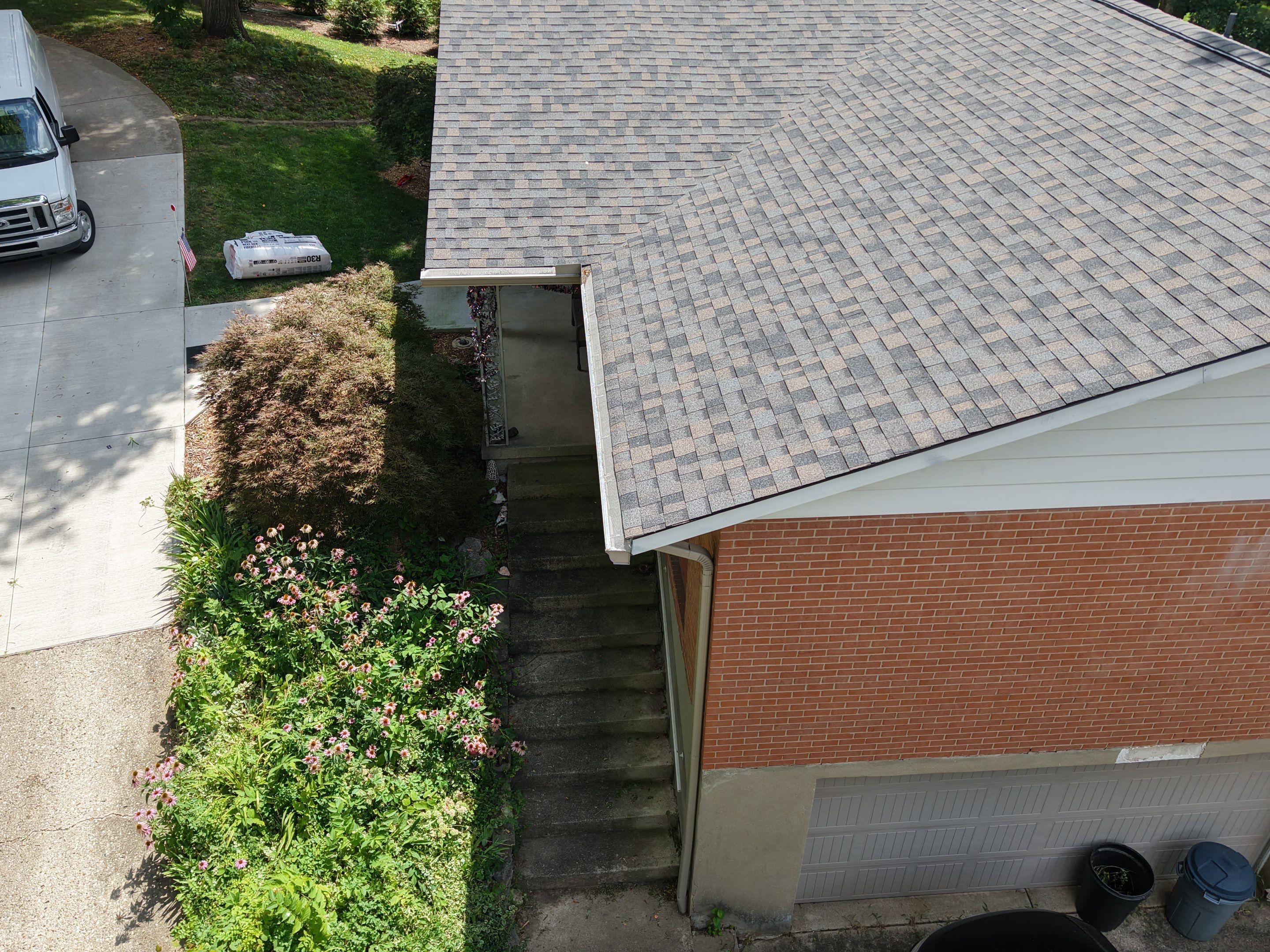 A completed roof and gutter run on a Beavercreek, Ohio home where Helping Hands Roofing installed gutter guards.