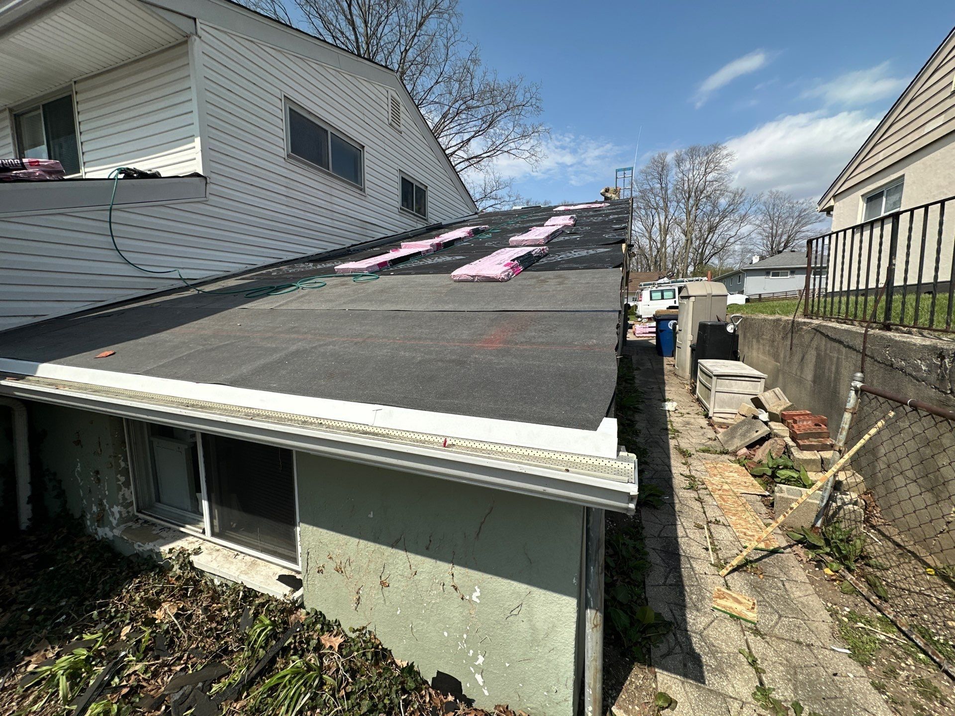 Shingle bundles staged on the underlayment over the back of the house, Dayton, Ohio.