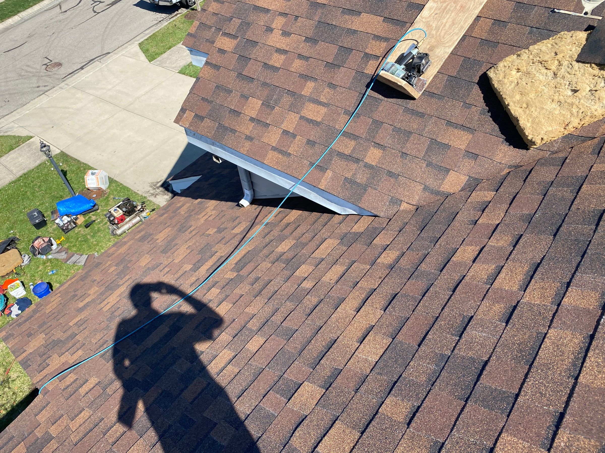 Nailer and blue air hose on a plank