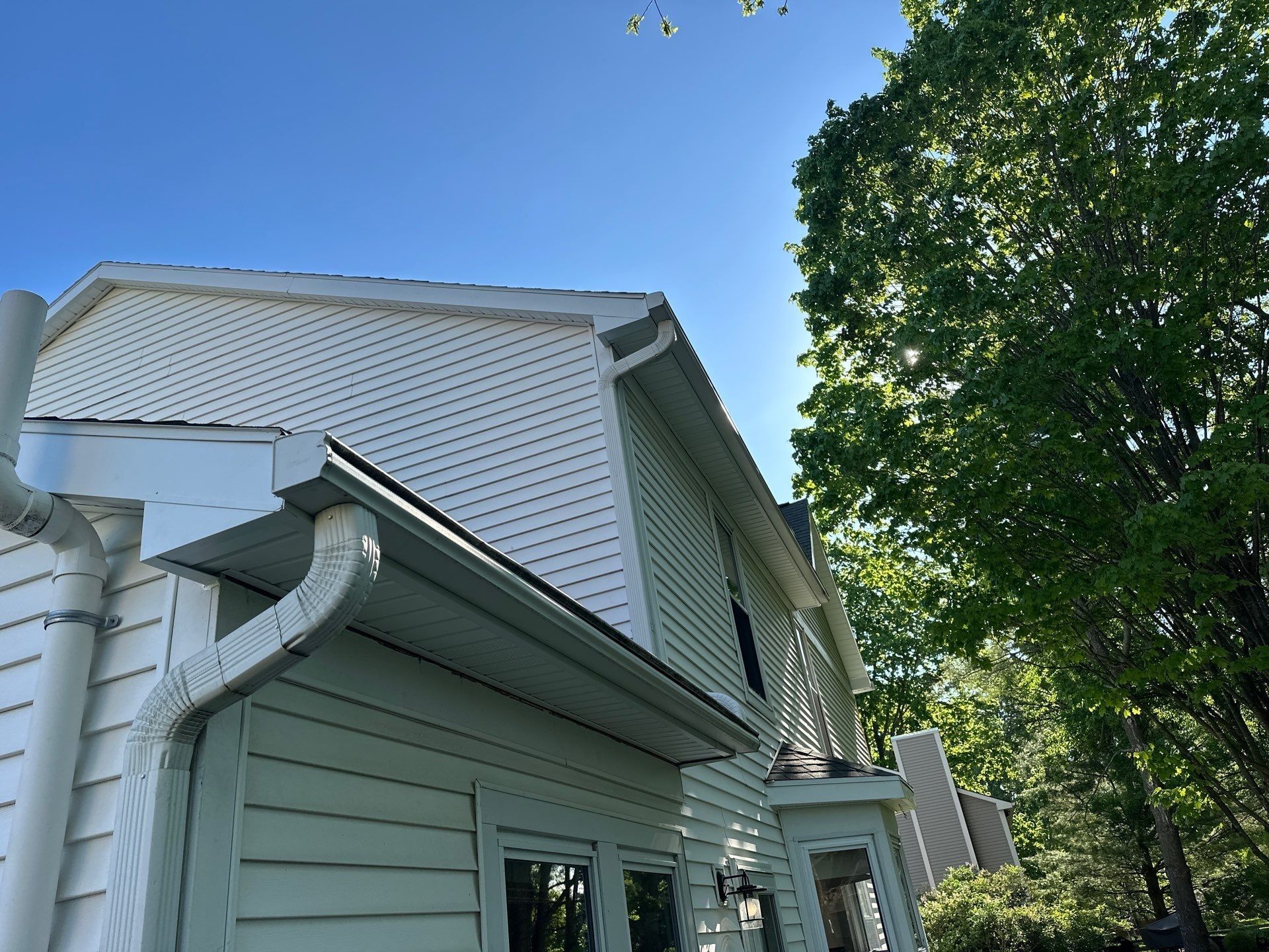 New metal fascia across the back of the house under a tall tree, Bellbrook, Ohio.