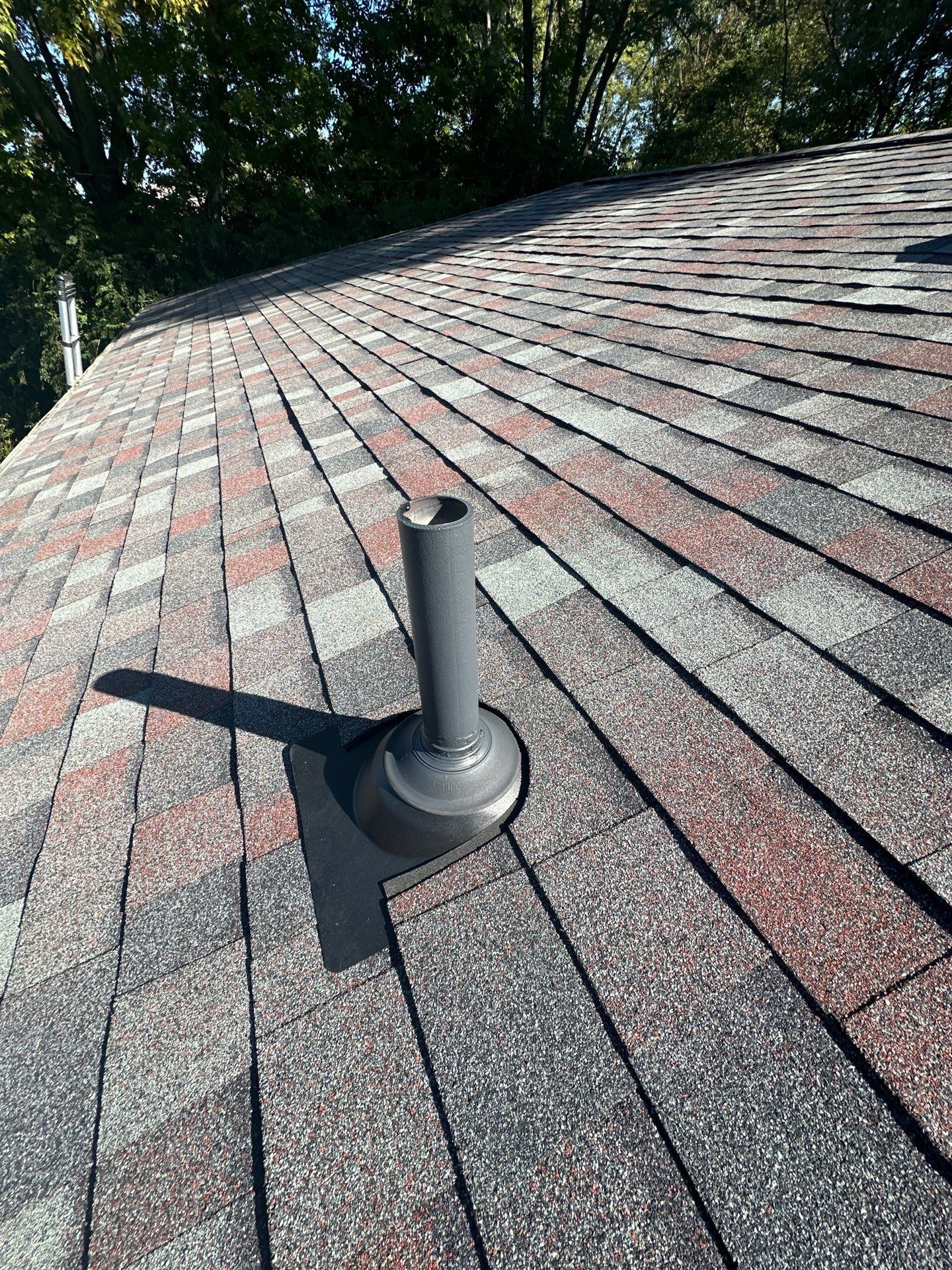 A new pipe vent and boot close up on the finished shingles, Kettering, Ohio.