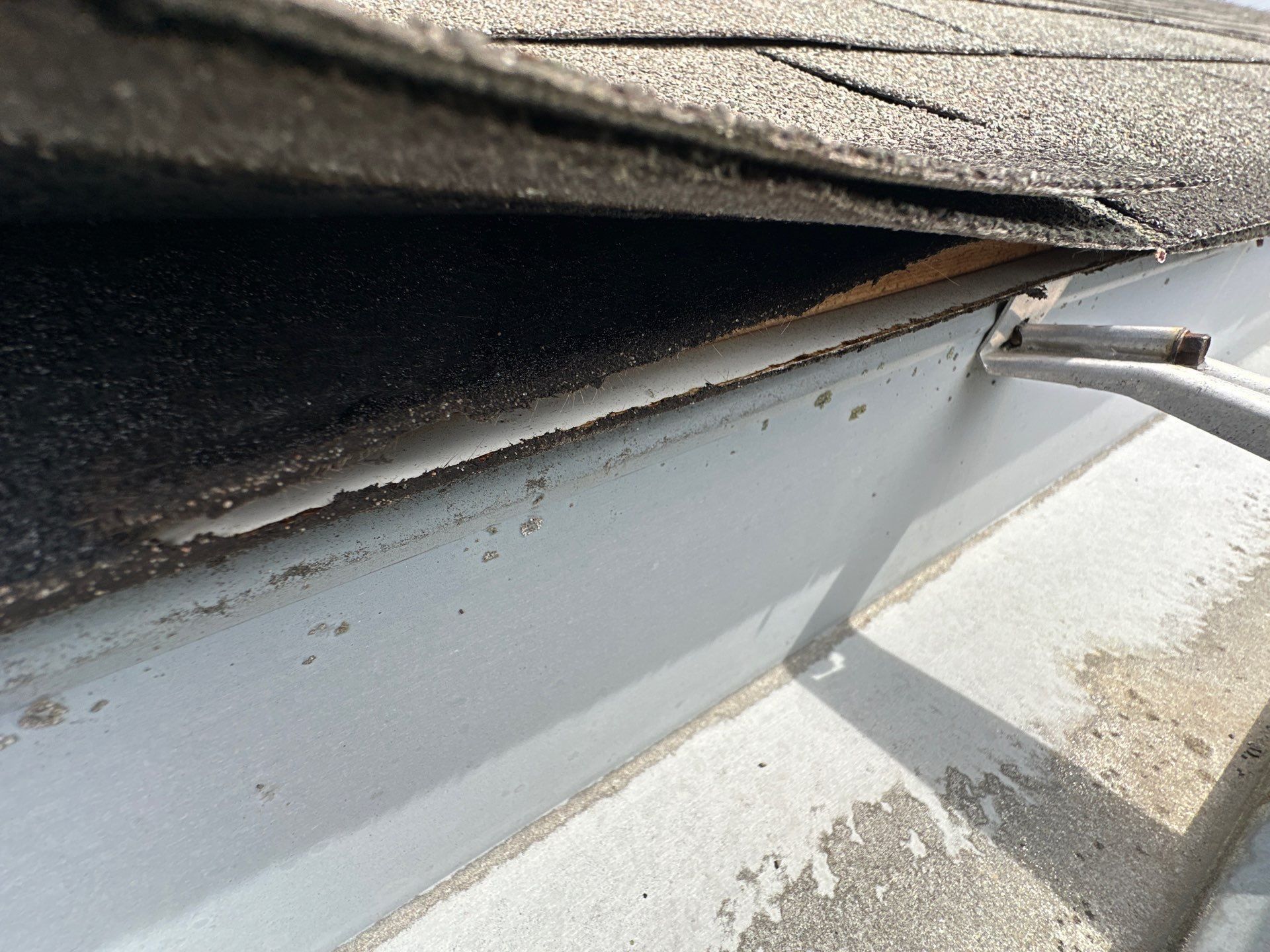 Inside the gutter at the eave