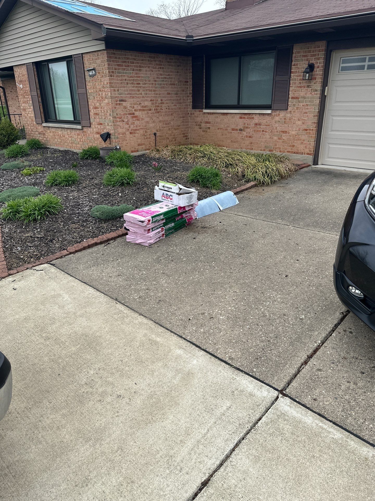 Shingle bundles on the driveway for the April repair, Beavercreek, Ohio.