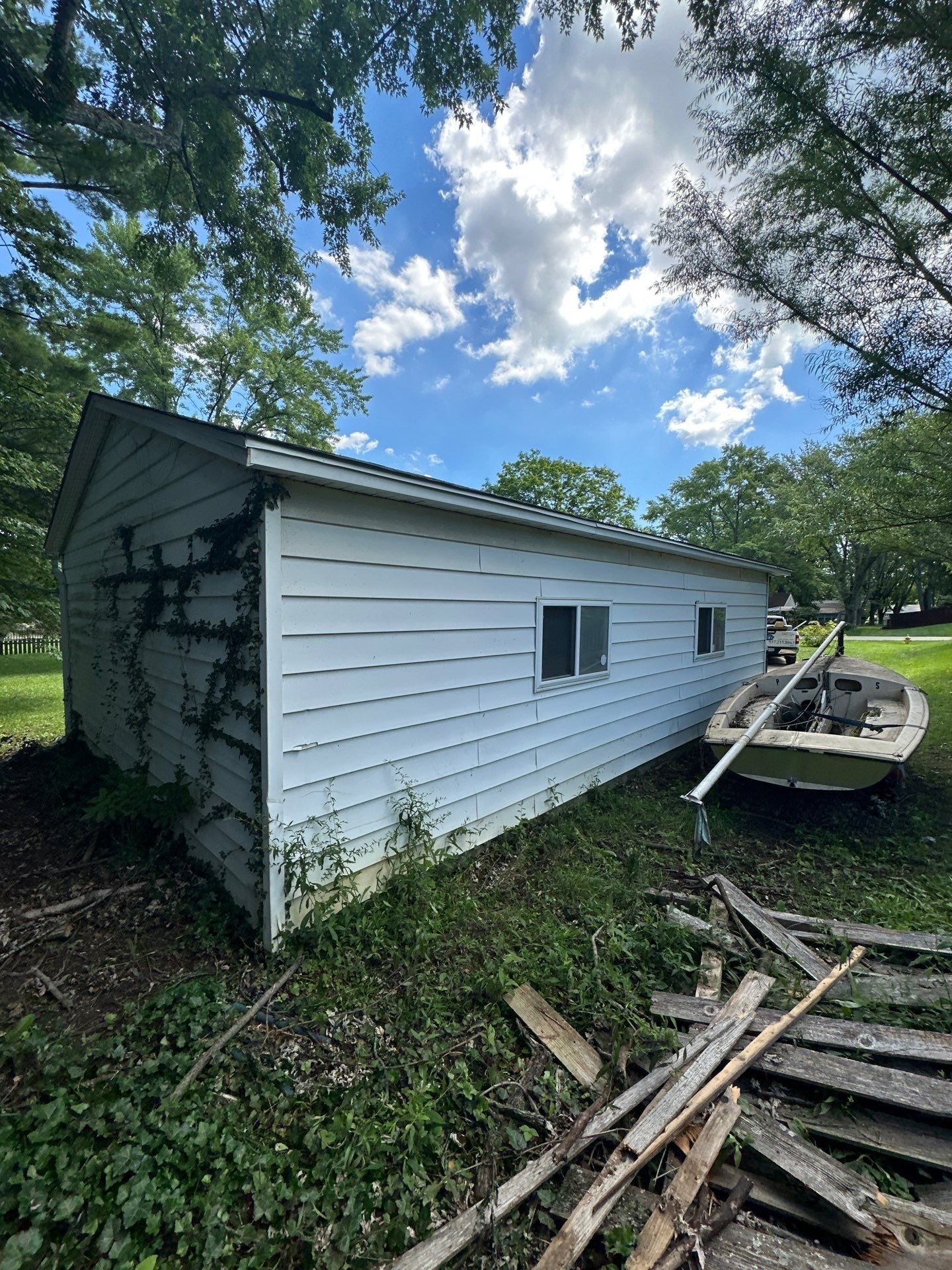 Outbuilding, new white fascia and ivy