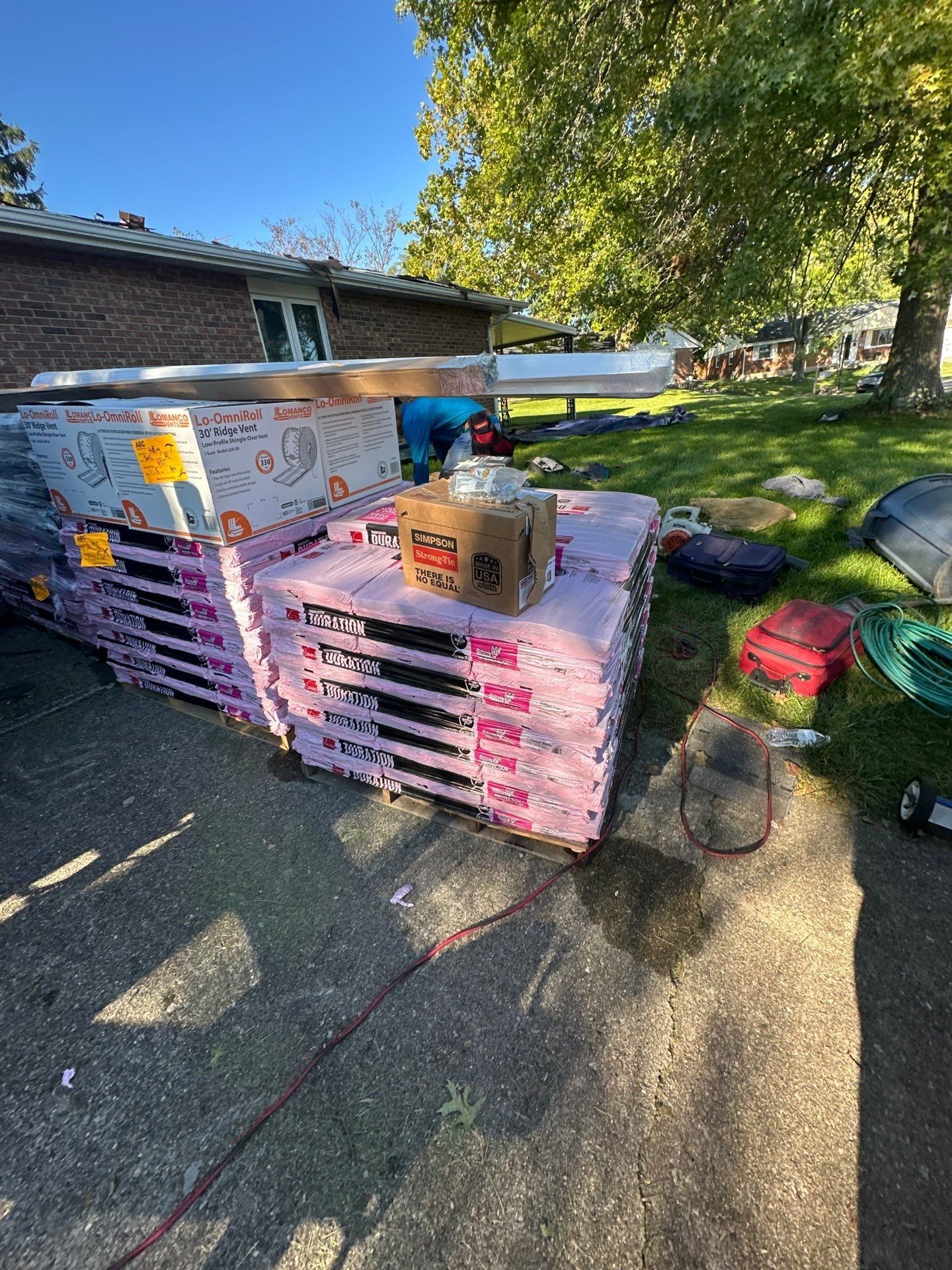 Pallets of new shingles and supplies on the driveway, West Carrollton, Ohio.
