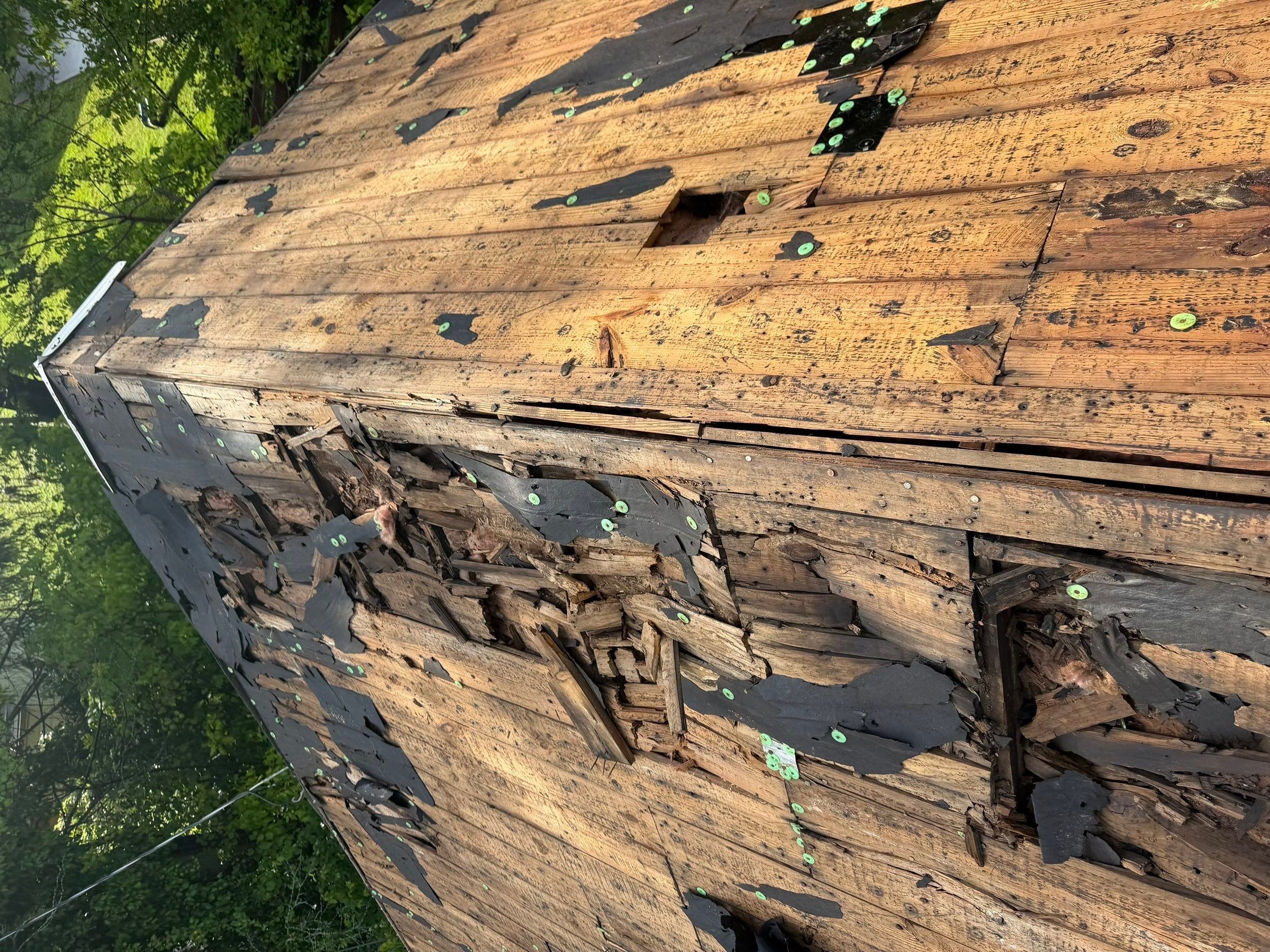 Splintered plank decking under the shingles