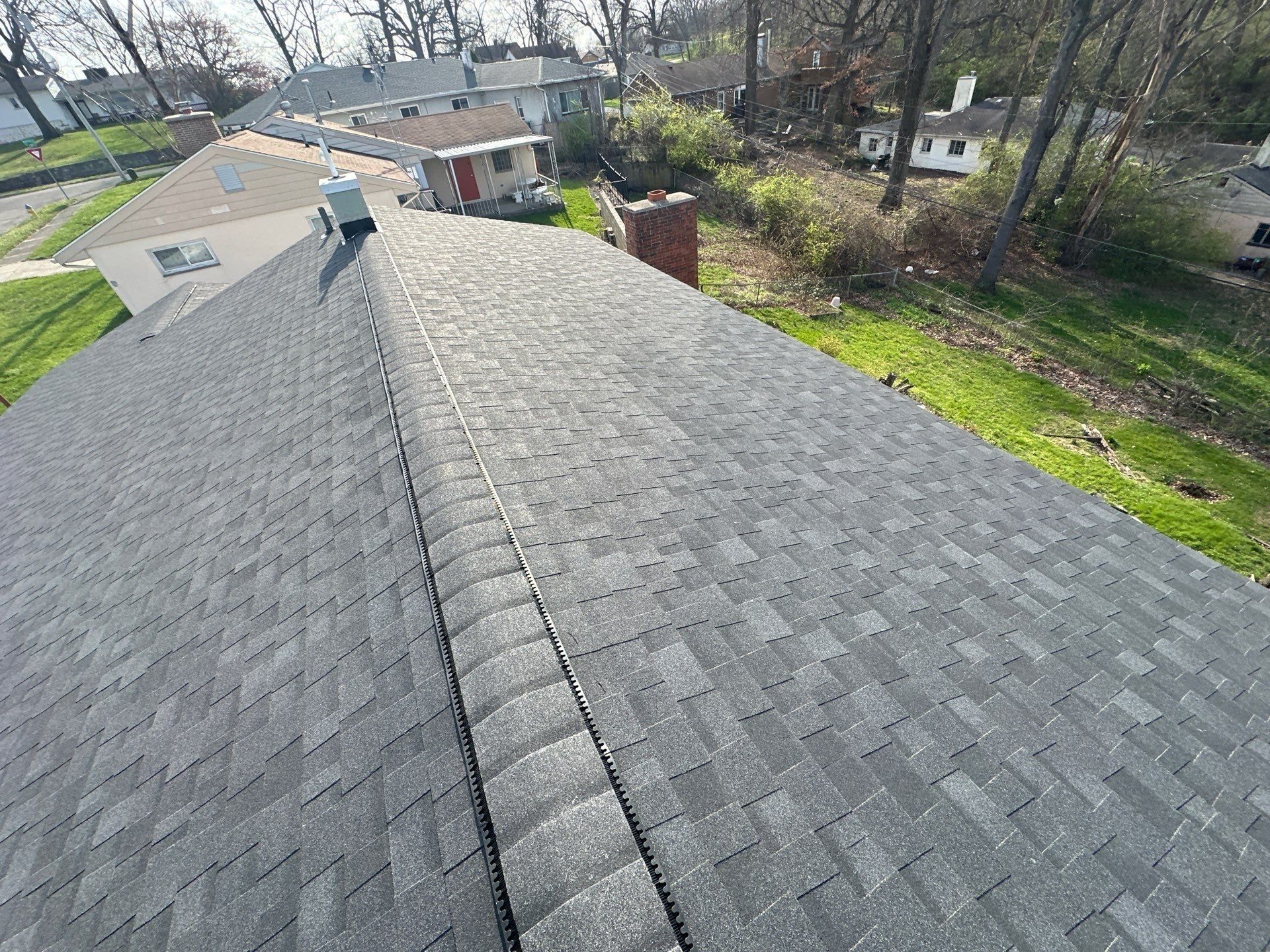 The finished ridge vent and shingles above the back yard, Dayton, Ohio.