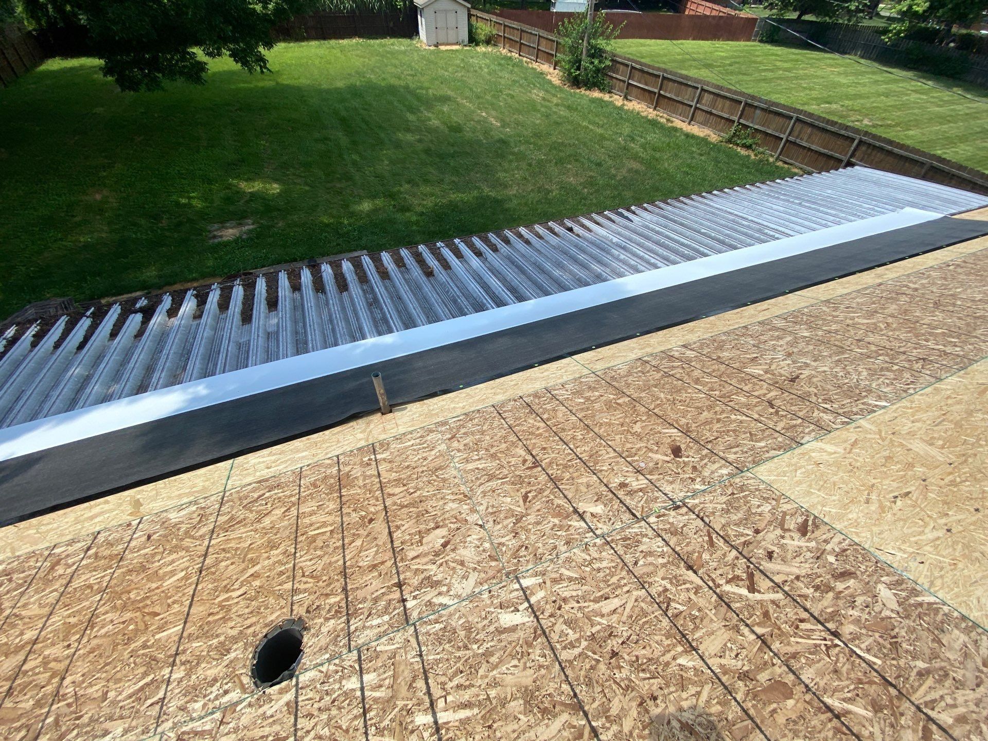 Membrane strip sealing the joint where the metal patio cover meets the roof, Beavercreek, Ohio.