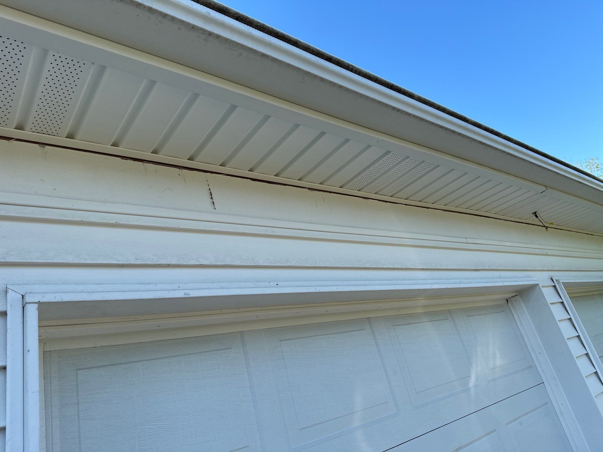 New vented soffit and white trim above the garage door, Bellbrook, Ohio.