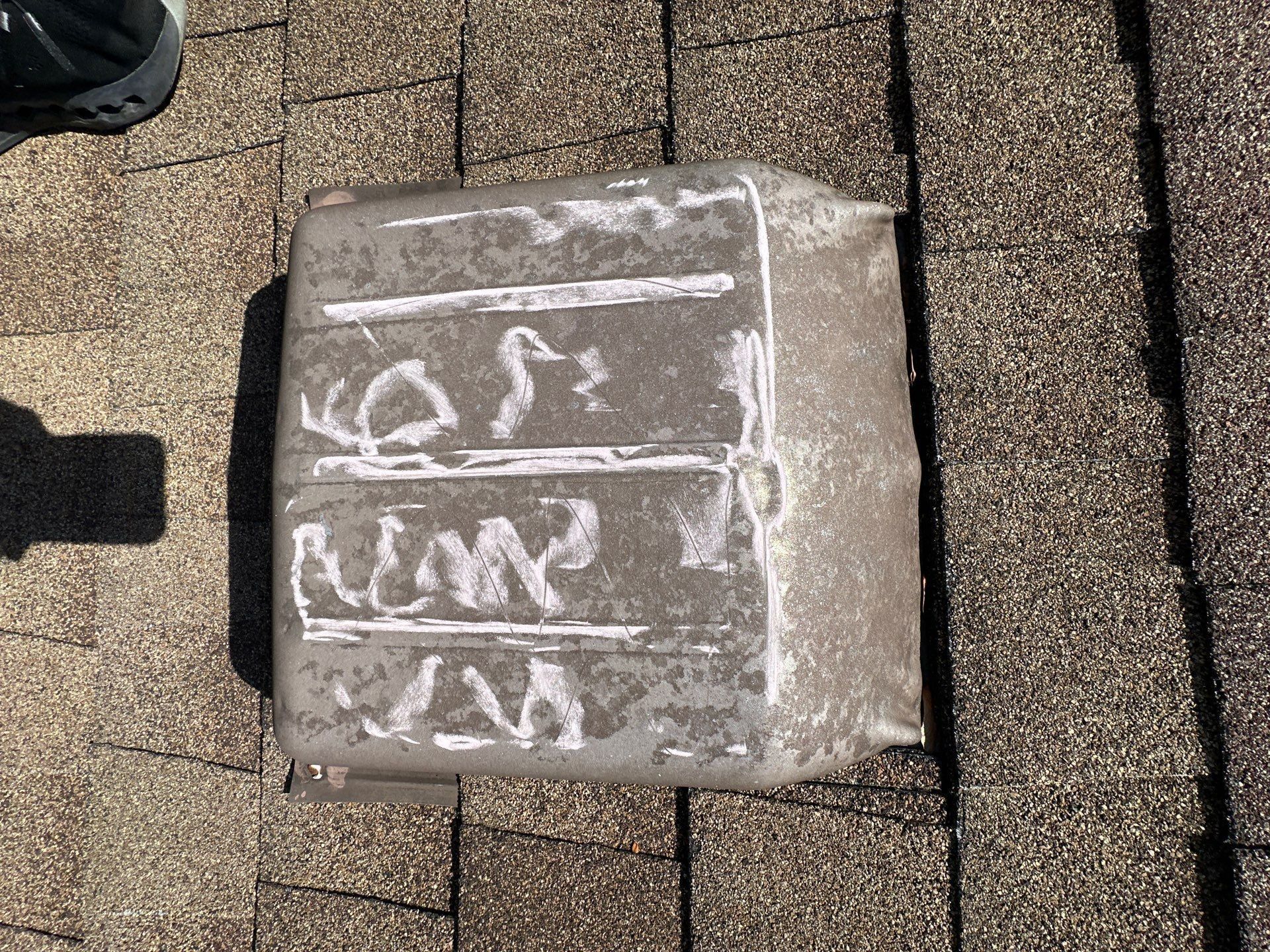 A dented roof vent marked in chalk for the claim, Xenia, Ohio.