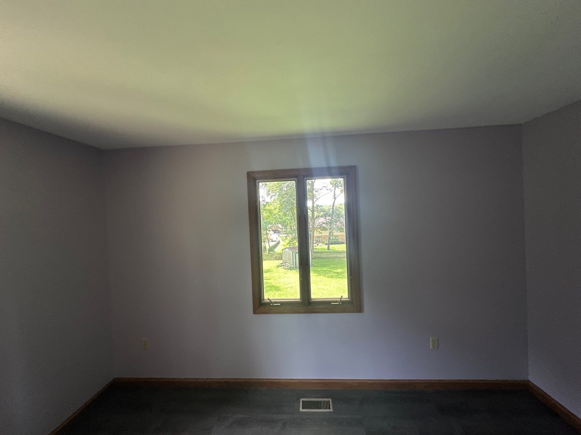 A repaired and painted bedroom with its window and new floor, Beavercreek, Ohio.